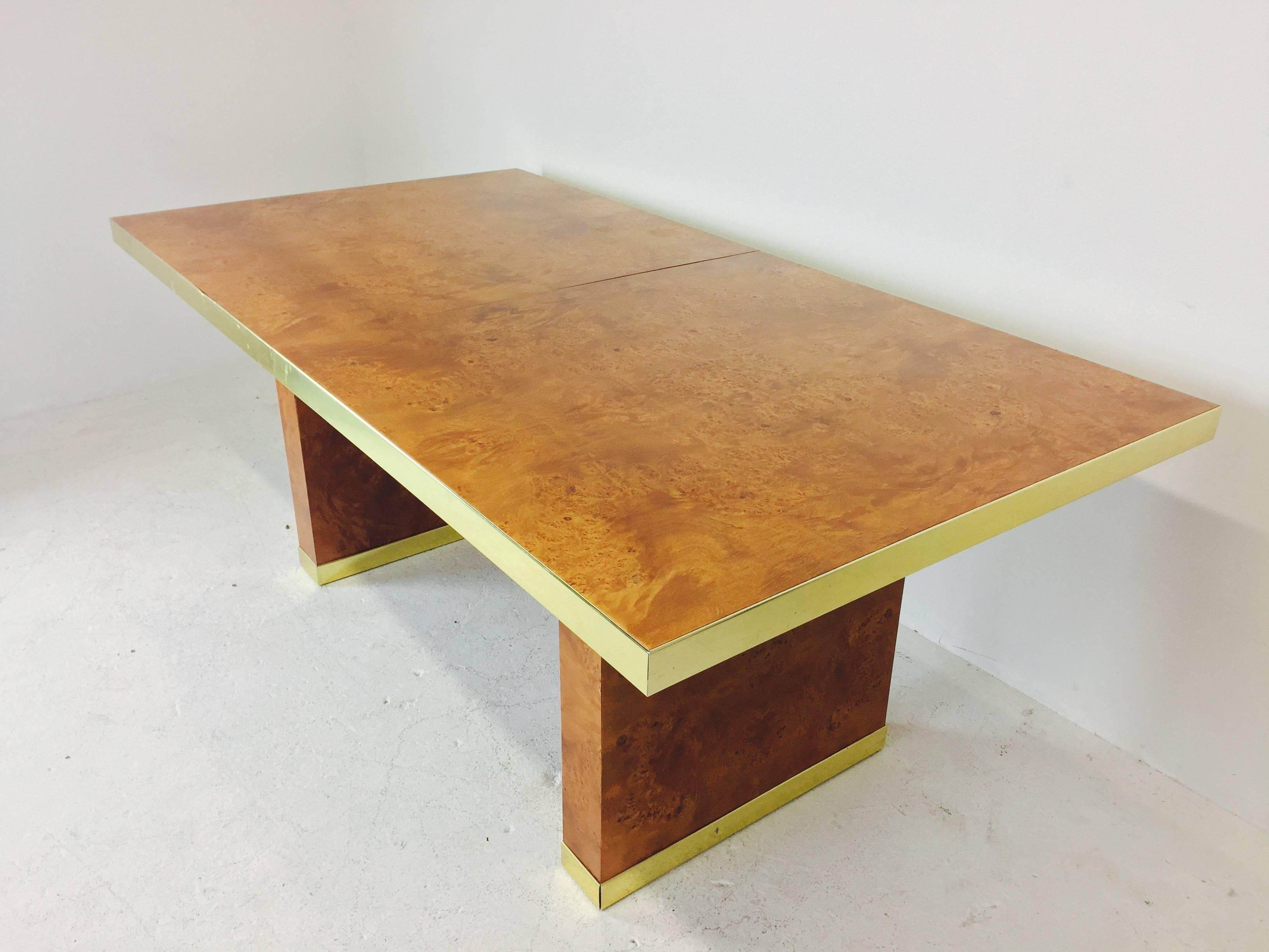 Burl wood and brass dining table by Pierre Cardin. Measures: Table has two 18