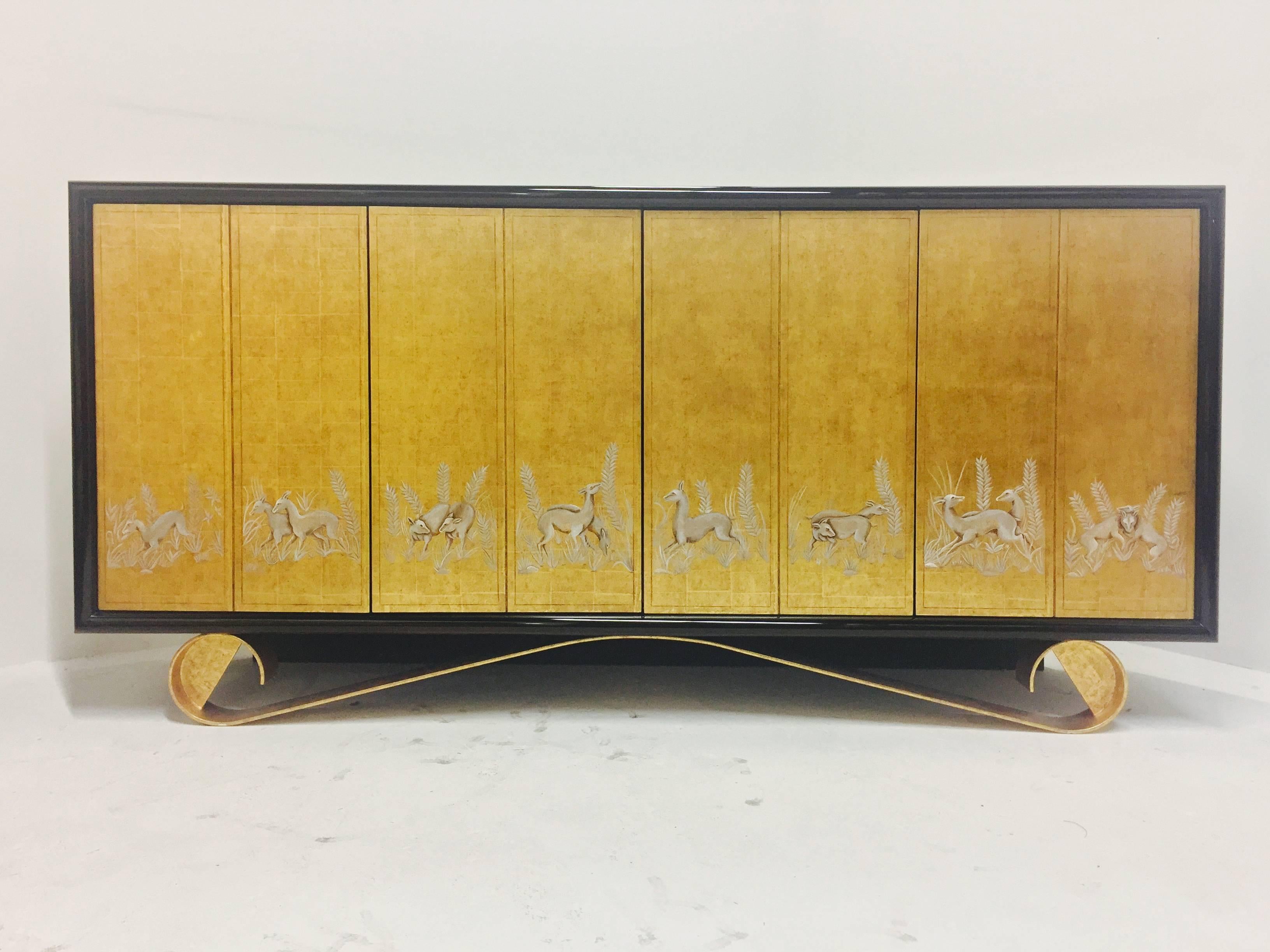 A true work of art, this Cassetto sideboard by Jean de Merry features four touch latch doors that with animal motifs on a gold leaf background, gilded scroll metal base and a black lacquer finish.

Dimensions: 78" W x 20" D x 38" T.