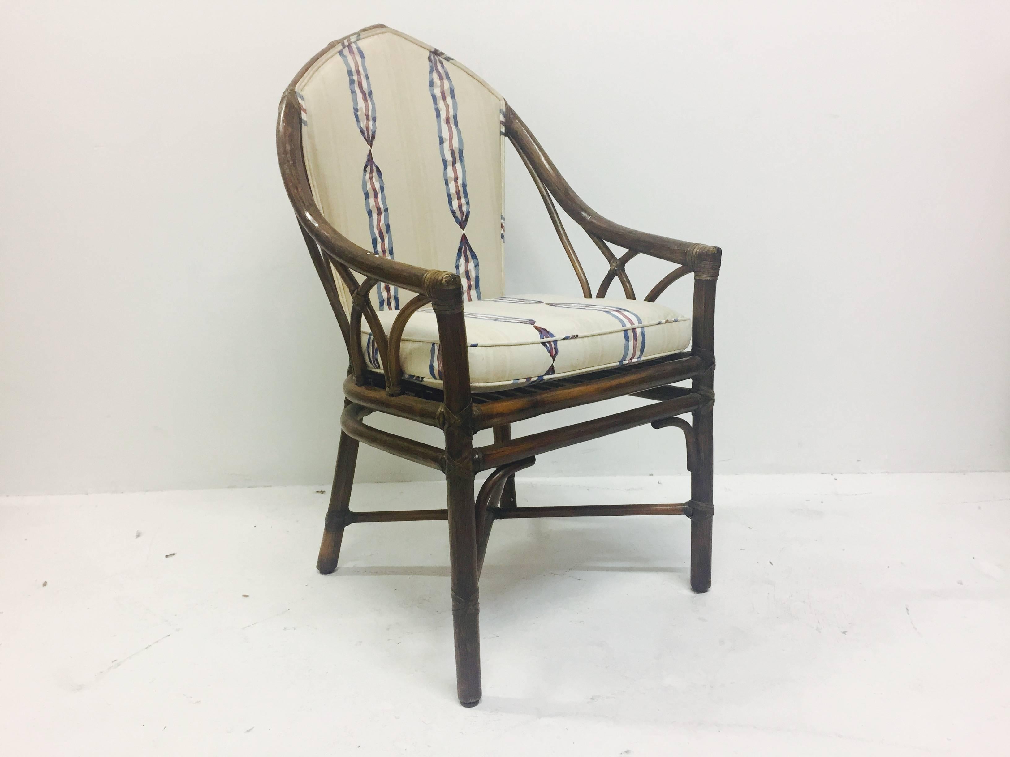 Set of six Gothic style rattan chairs by McGuire. New upholstery and refinishing is recommended. There is some loss with leather strapping around armrest.

dimensions: 22