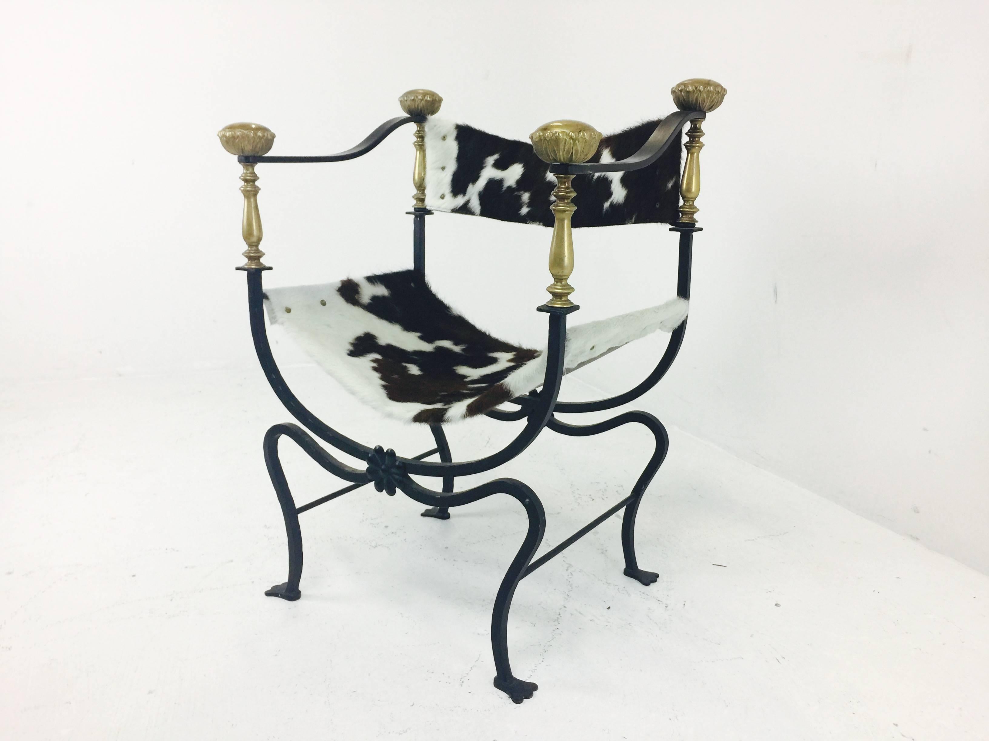 Italian Campaign style iron cowhide chair. New cowhide was recently added.
Brass has a nice aged patina, circa 1960s.

Dimensions: 23.5" W x 19" D x 31" T.
Seat height 14".
