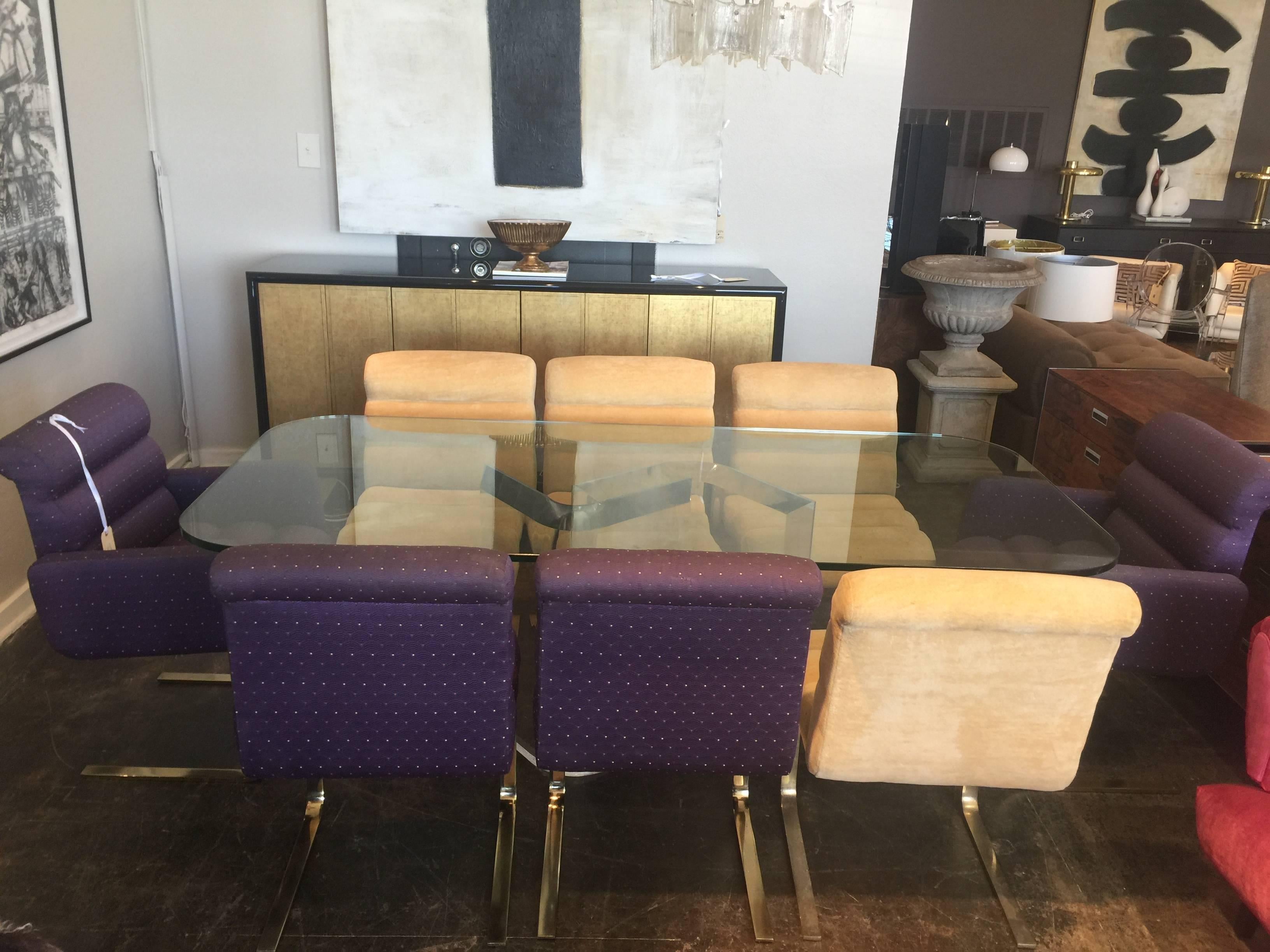Set of eight comfortable cantilever Lugano dining chairs by Mariani for Pace Collection. Set has two arm and six side chairs. Half of the chairs have beige upholstery and the other half has purple upholstery. New Upholstery is