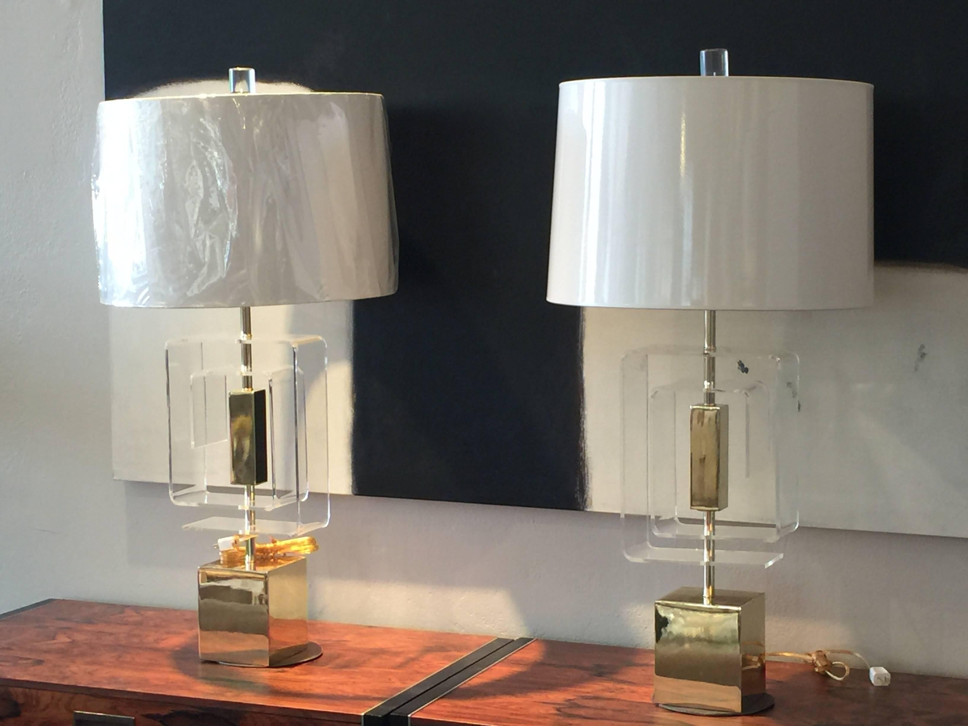 Pair of Lucite and brass lamps by Laurel. There is a minor imperfection on top of one of the bases. Lamps have recently been newly wired.

Dimensions: 9" W x 5" D x 26" T (to socket).

Shades not included.