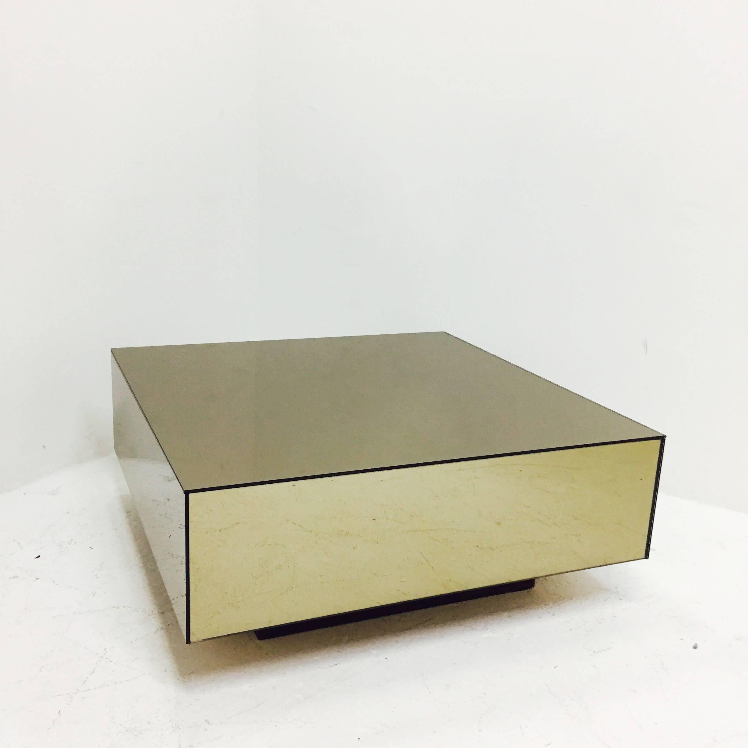 Bronze mirrored cube coffee table with plinth base in the style of Milo Baughman. 

Dimensions: 36.5" W x 36.5" D x15" T.