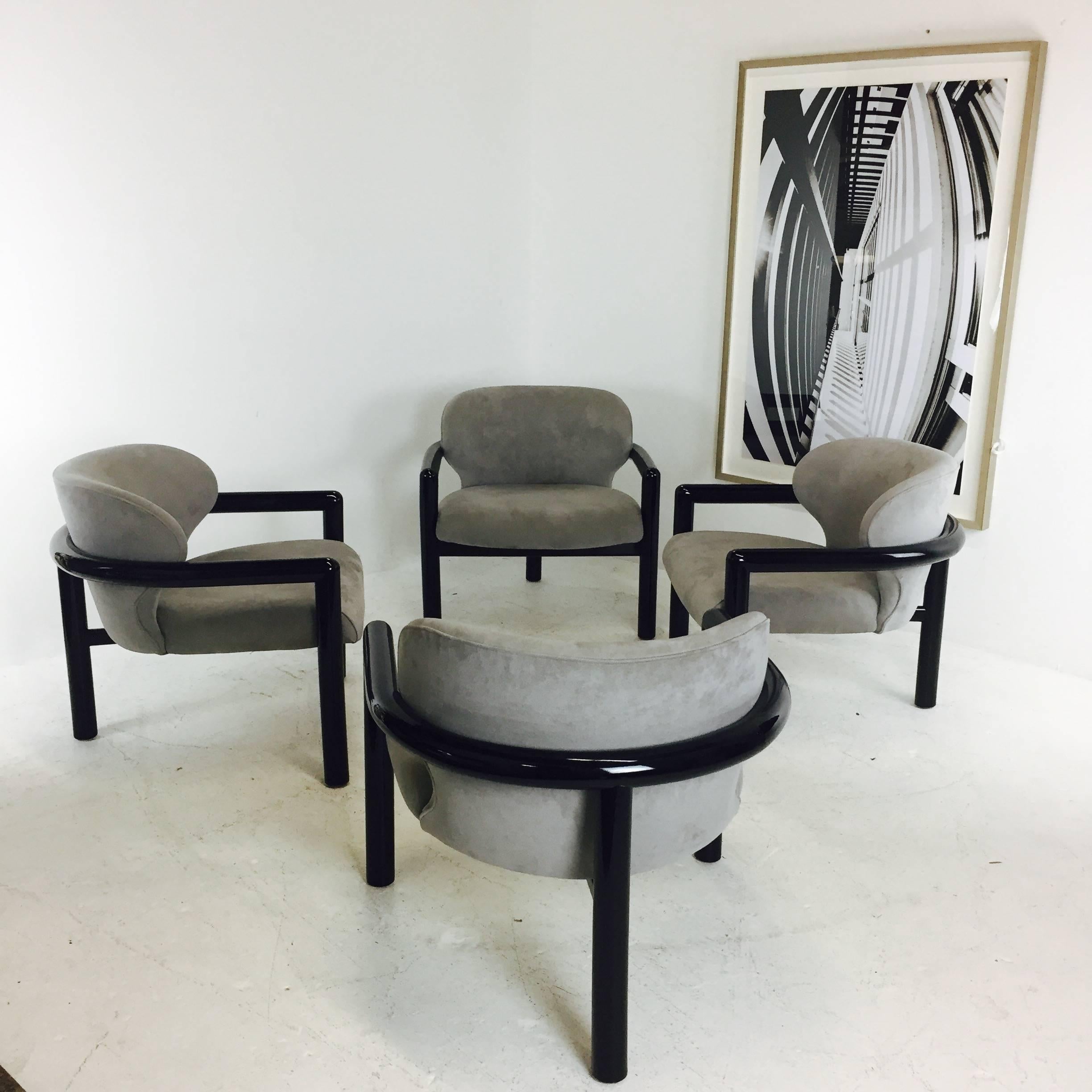 Pair of three legged lounge chairs with a black lacquered finish. Upholstered in a gray ultrasuede. In good vintage condition with minimal signs of wear, circa 1980s

Two pairs available

dimensions: 29