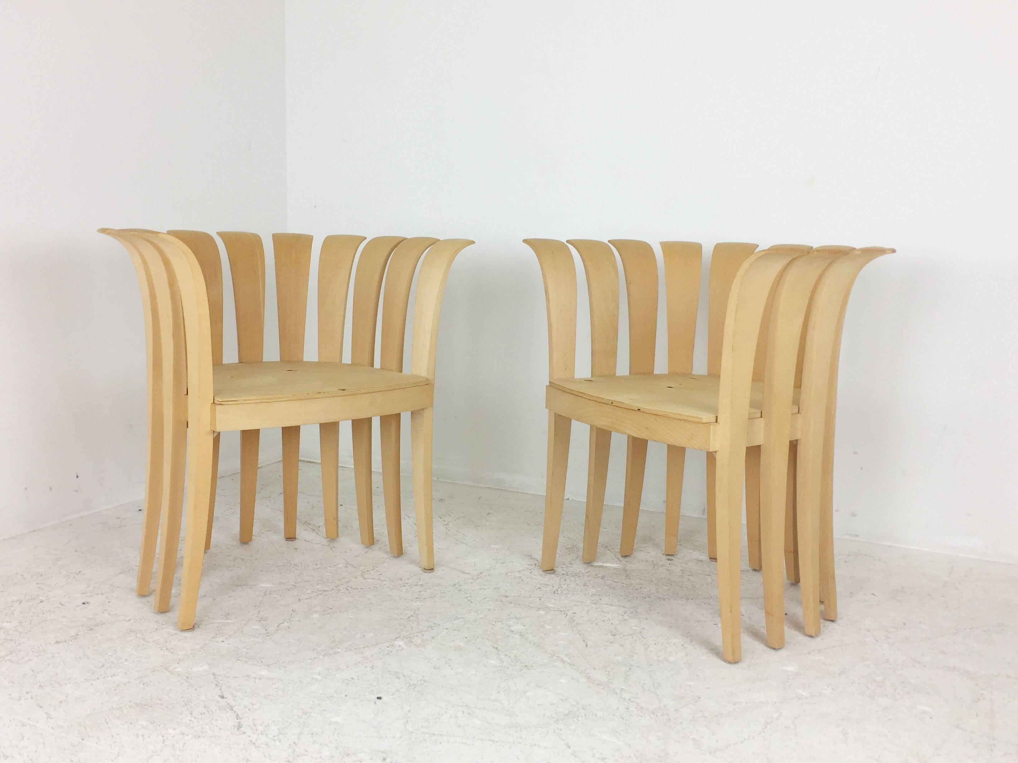 Pair of sculptural wood petal shaped armchairs. Individual panels surround the chair's form and creates a cozy feel. New cushions are needed.

 One set of pair available 

dimensions: 28" W x 24" D x 29" T
seat height 18".