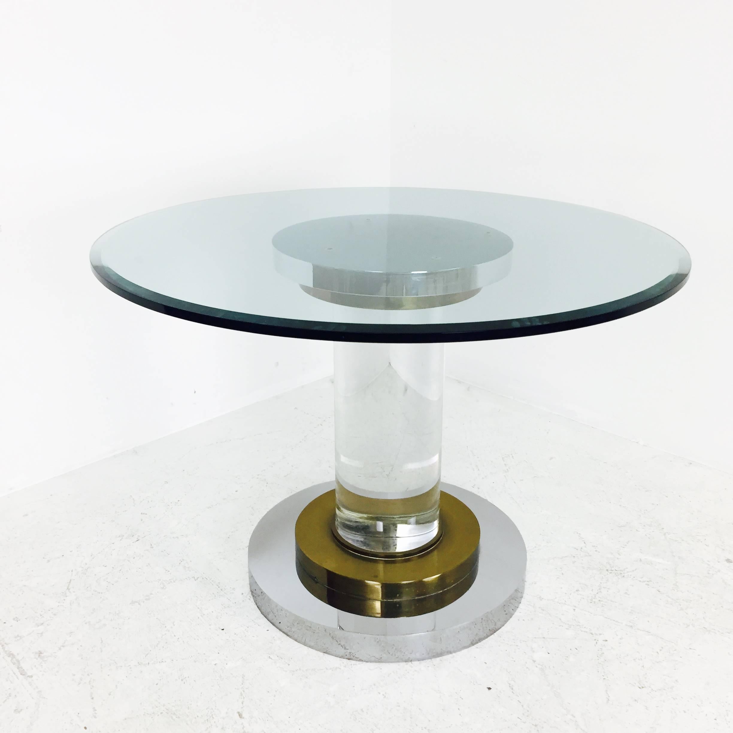 Lucite pedestal dining table with polished stainless and brass accents. Glass top does have surface scratches, circa 1970s

Table only

dimensions: 48" diameter  x 29" tall
3/4" glass
24"diameter pedestal base.