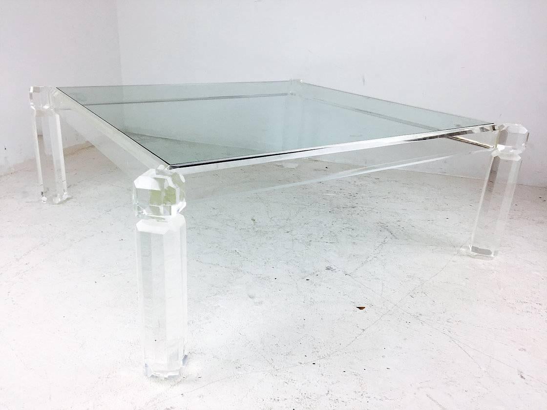 Square Lucite and glass coffee table. There some minor abrasions on Lucite and glass, circa 1980s.

Dimensions: 44" W x 44" D x 16" T.