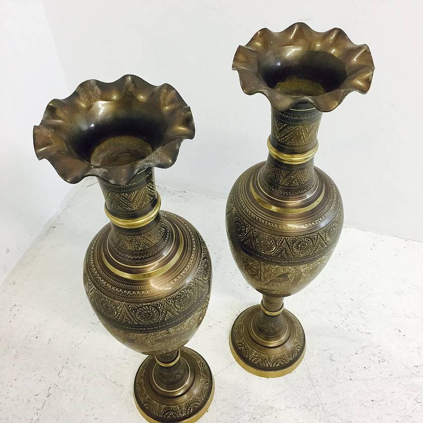 Pair of tall brass etched Afghan vases. These vases are in good vintage condition and does show some wear due to age and use.

Dimensions: 10