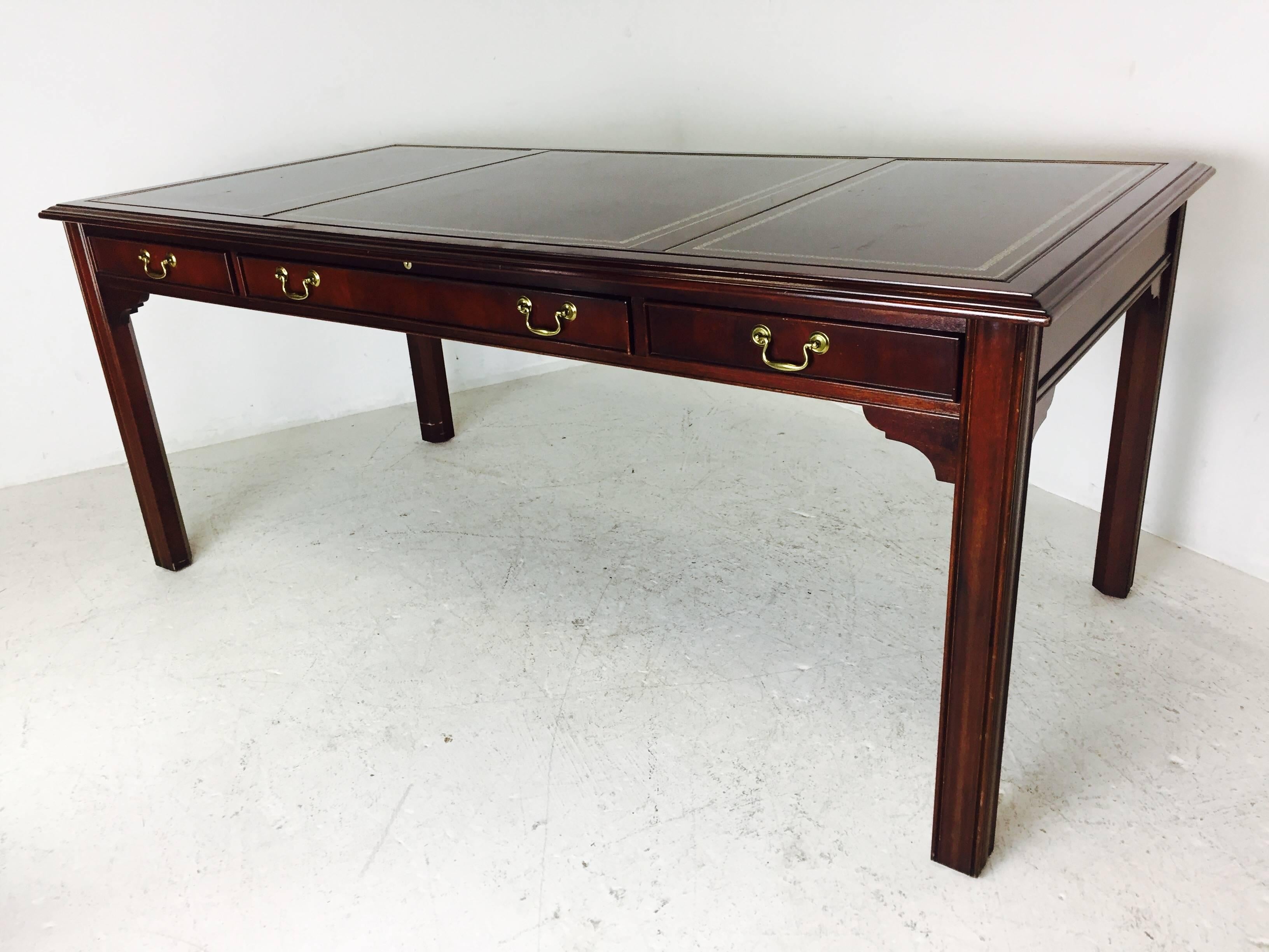 Writing desk with leather panel top by Sligh. Desk is in good vintage condition with signs of wear from use and age of piece, circa 1980s.

Dimensions: 72" wide x 36" deep x 30" tall.