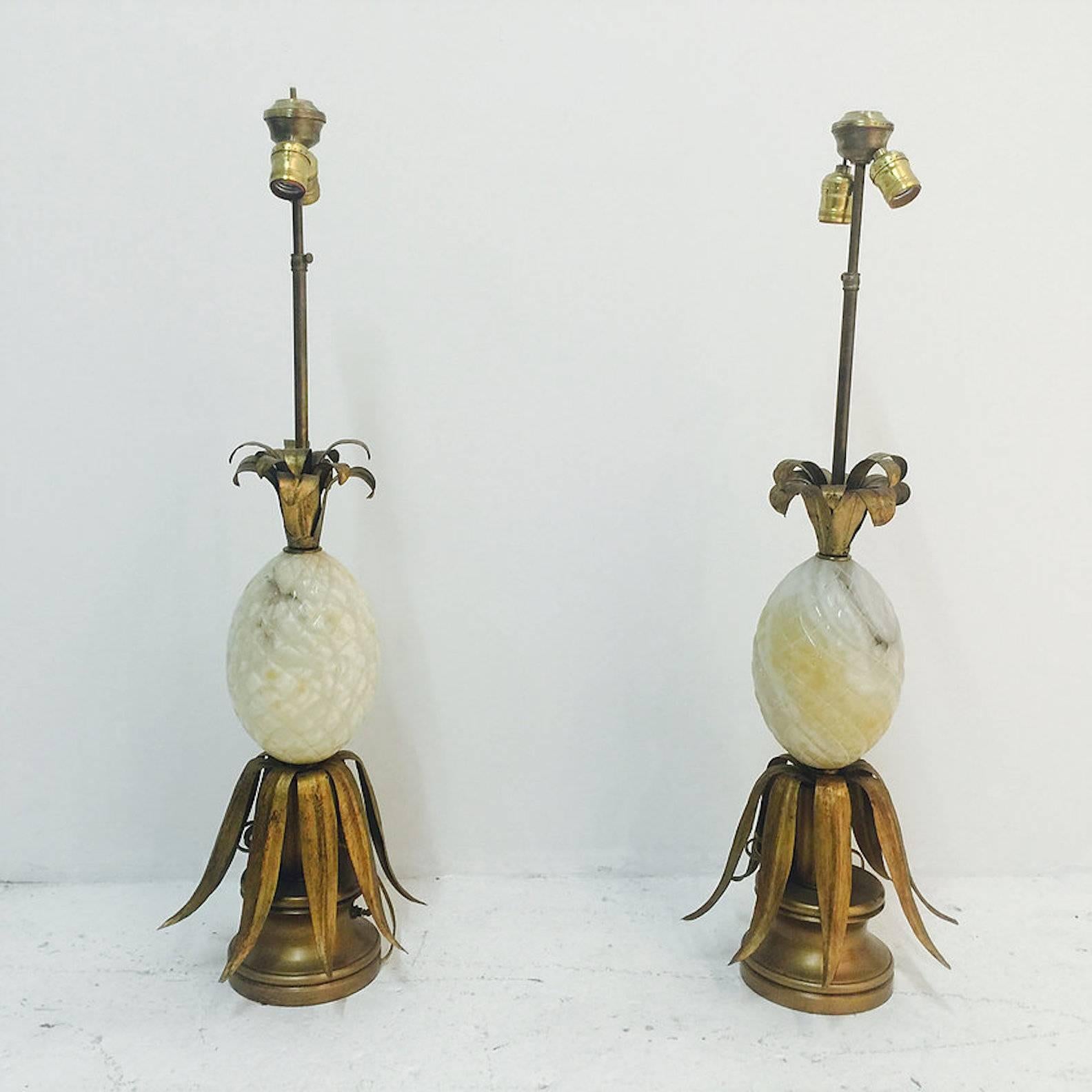 Pair of carved alabaster pineapple lamps with bronze finish. There is visible wear due to age. Original wiring. circa 1950s

Lamps do need repairing

dimensions: 11