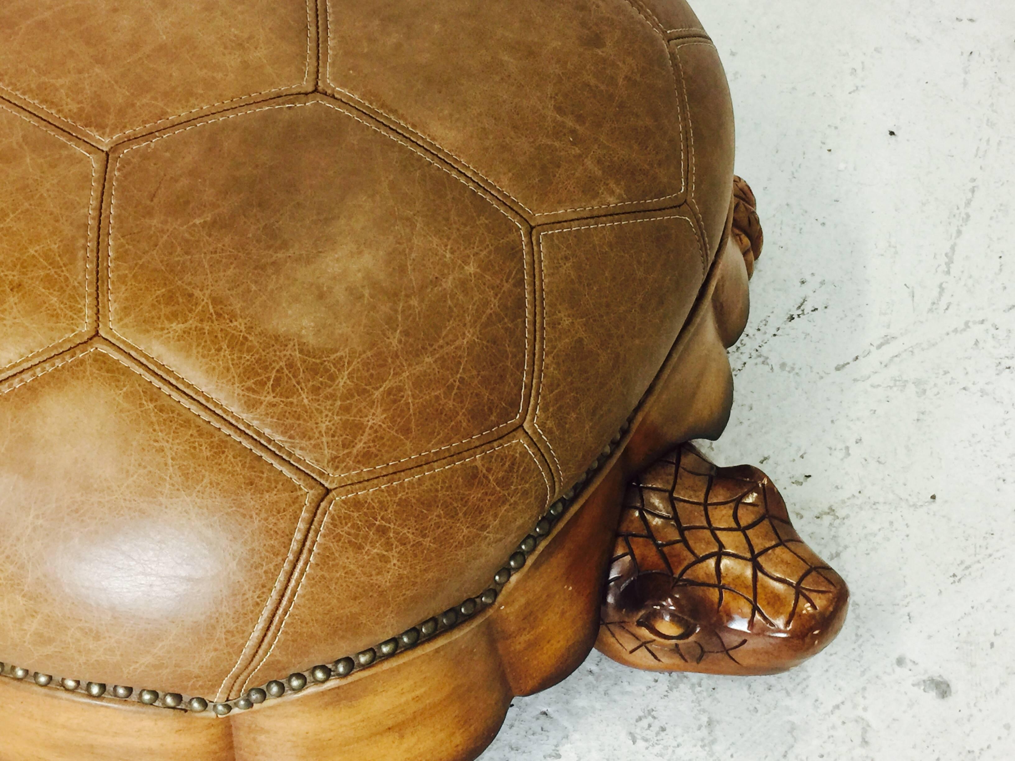 Large leather and wood turtle ottoman. In found condition with some wear from use.

Dimensions: 36