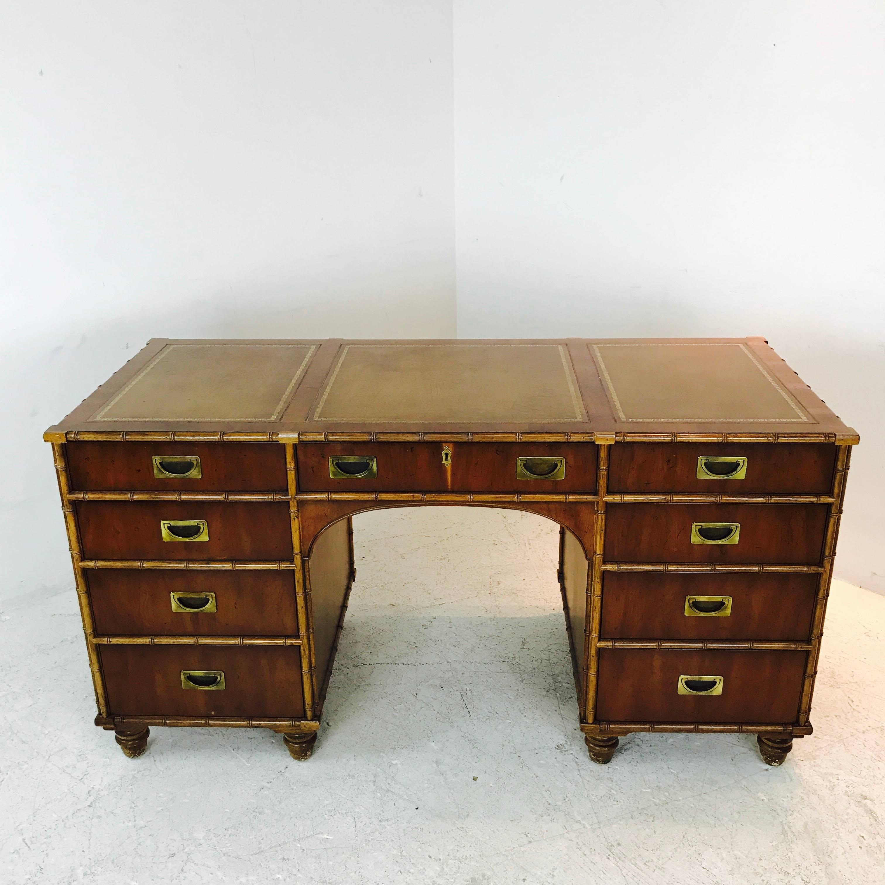 Henredon faux bamboo desk with inlaid leather top. In good vintage condition with visible wear from age and use, circa 1960s

dimensions:
60" W x 30" D x 29" T.