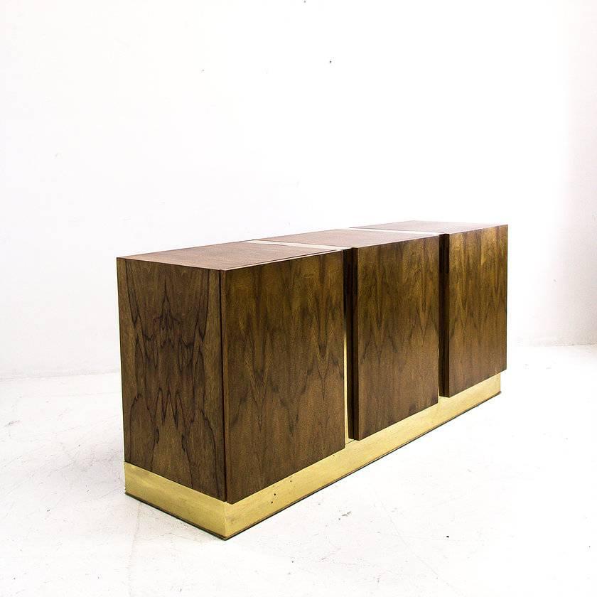 Zebra wood and brass credenza by Milo Baughman. The credenza has two areas with open shelving and center has drawers. In good vintage condition with some patina on brass, circa 1970s

Dimensions: 63