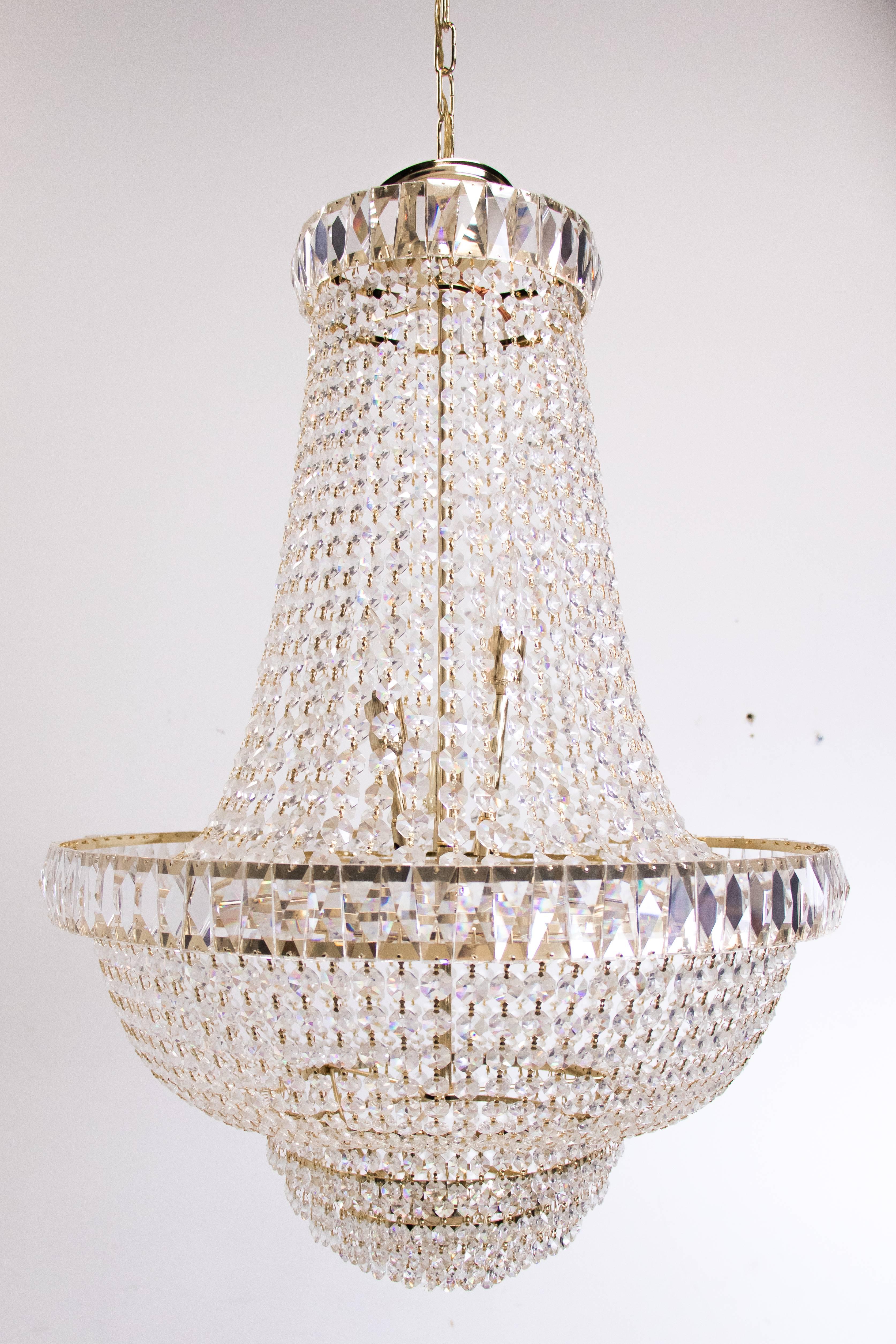Nine-light crystal chandelier. The chandelier is in good vintage condition with signs of wear due to age.

Dimensions: 24