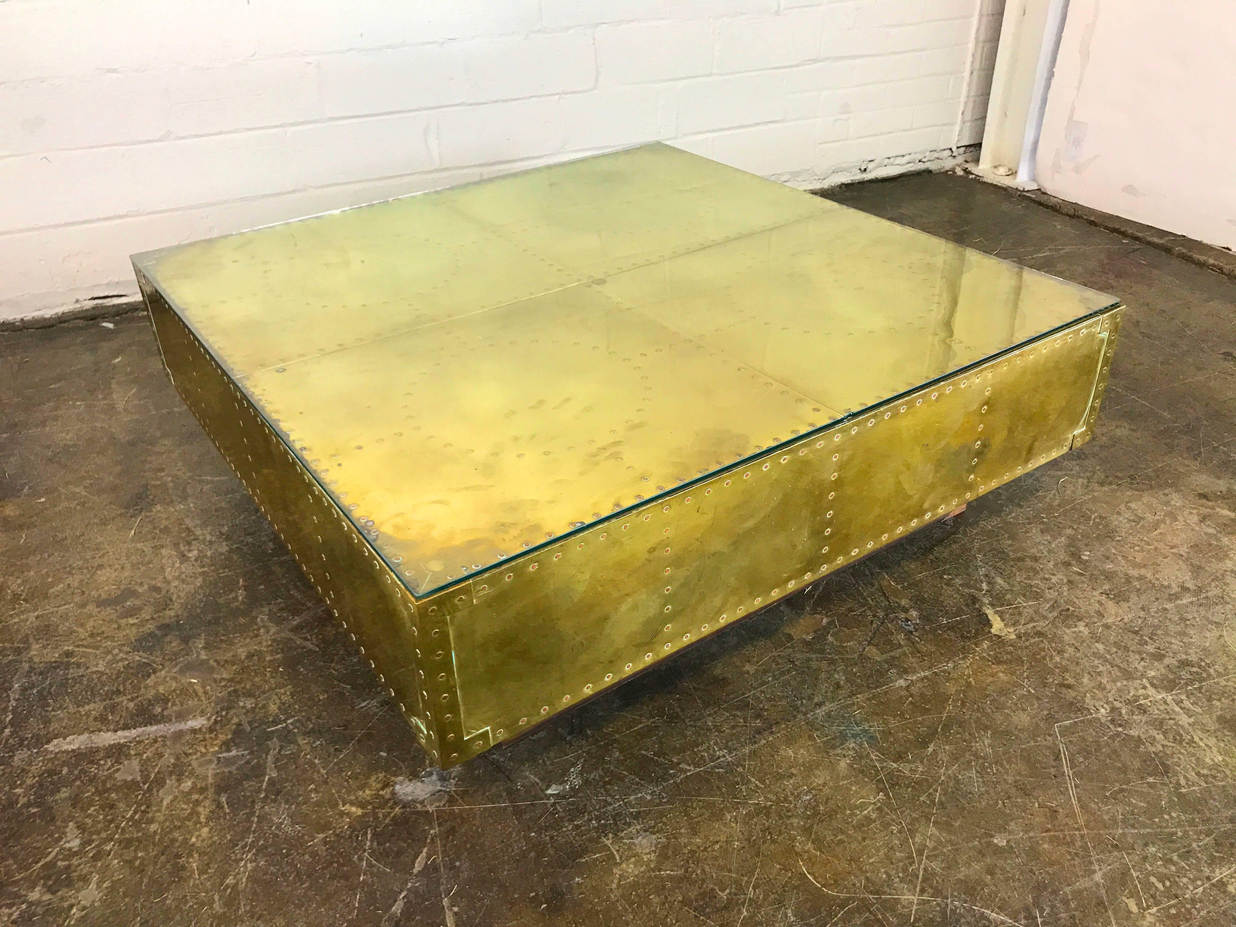 Sarreid brass coffee table with a warm patina. In good found vintage condition with some oxidation and wear due to age and use. The table does come with a glass top, circa 1970s. 

Dimensions: 40