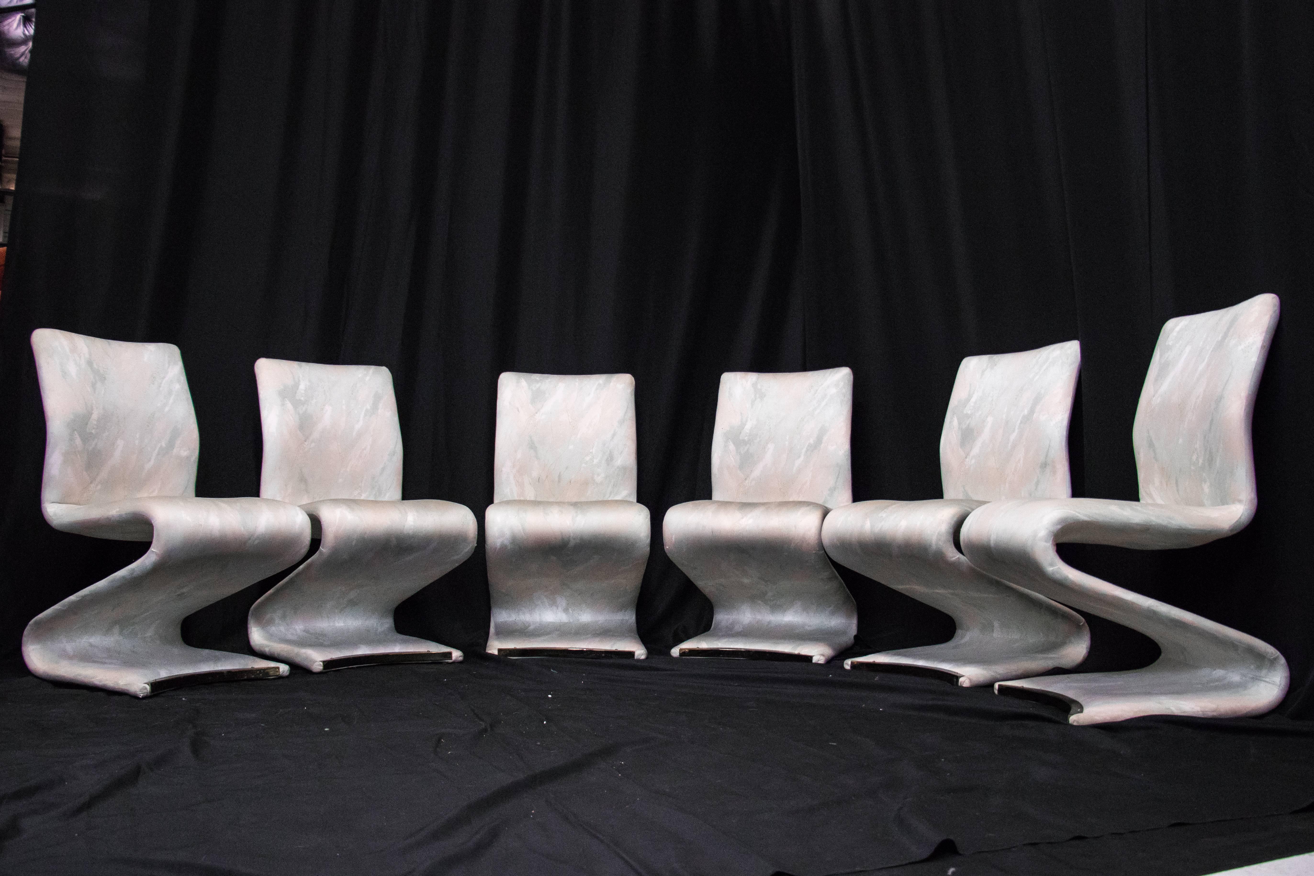 Set of six "Z" shaped upholstered dining chairs. Chairs are in good vintage with wear from use and age, circa 1980s

New upholstery is recommended 

See our listing on the Lucite dining table.

Measures: 19" W x 23" D x 37"