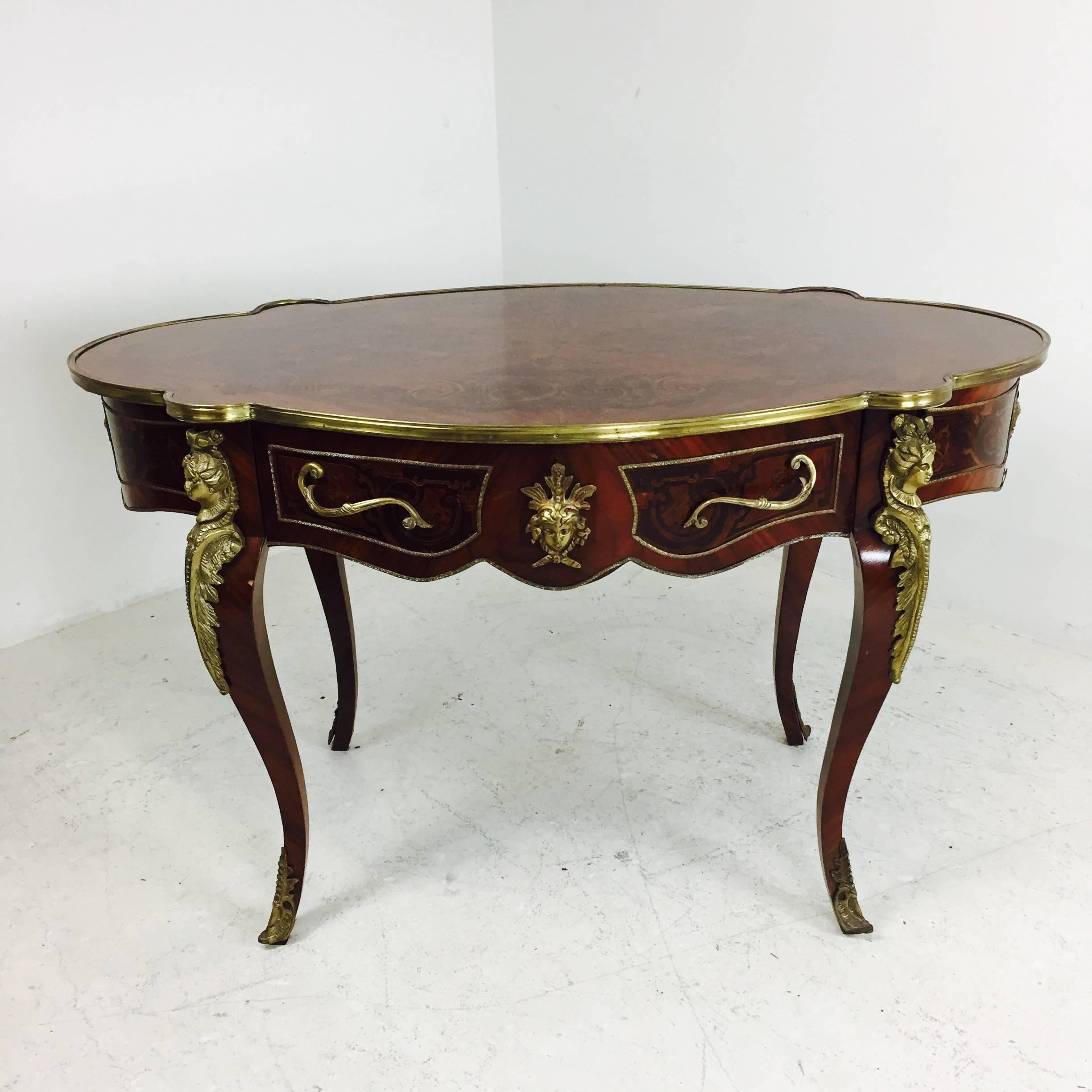 Ormolu-mounted marquetry inlay desk in the style of  Francois Linke. The marquetry is small pieces of different colored woods that create ornamental inlay designs. Ormolu on the outer side of the legs on desk.

Dimensions: 51