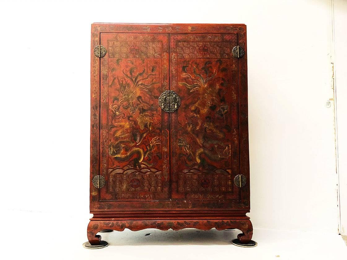 Carved Red Asian Armoire / Liquor Cabinet. There are some wear and tear due to age and use, circa late 19th century

dimensions: 43