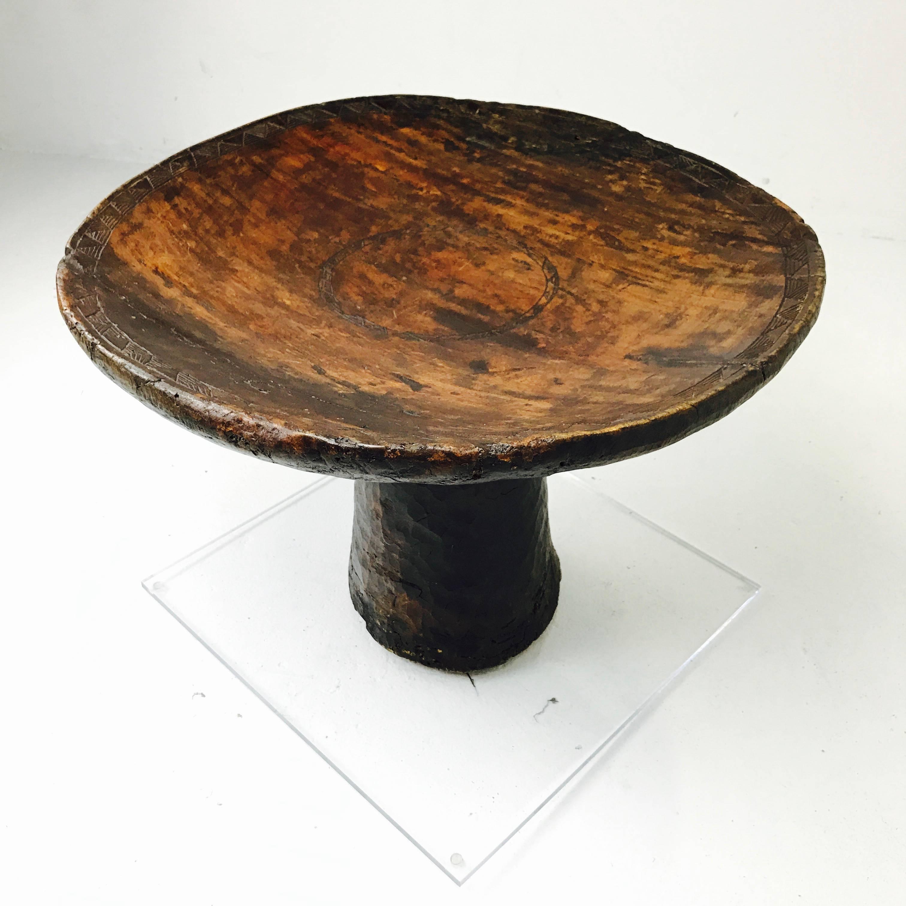 African carved ceremonial wedding stool/table with Lucite base. Once used to place wedding gifts on. Carved from a one piece of solid wood in the early 1900s. Was modernized with a Lucite base. Table does show wear to due age and