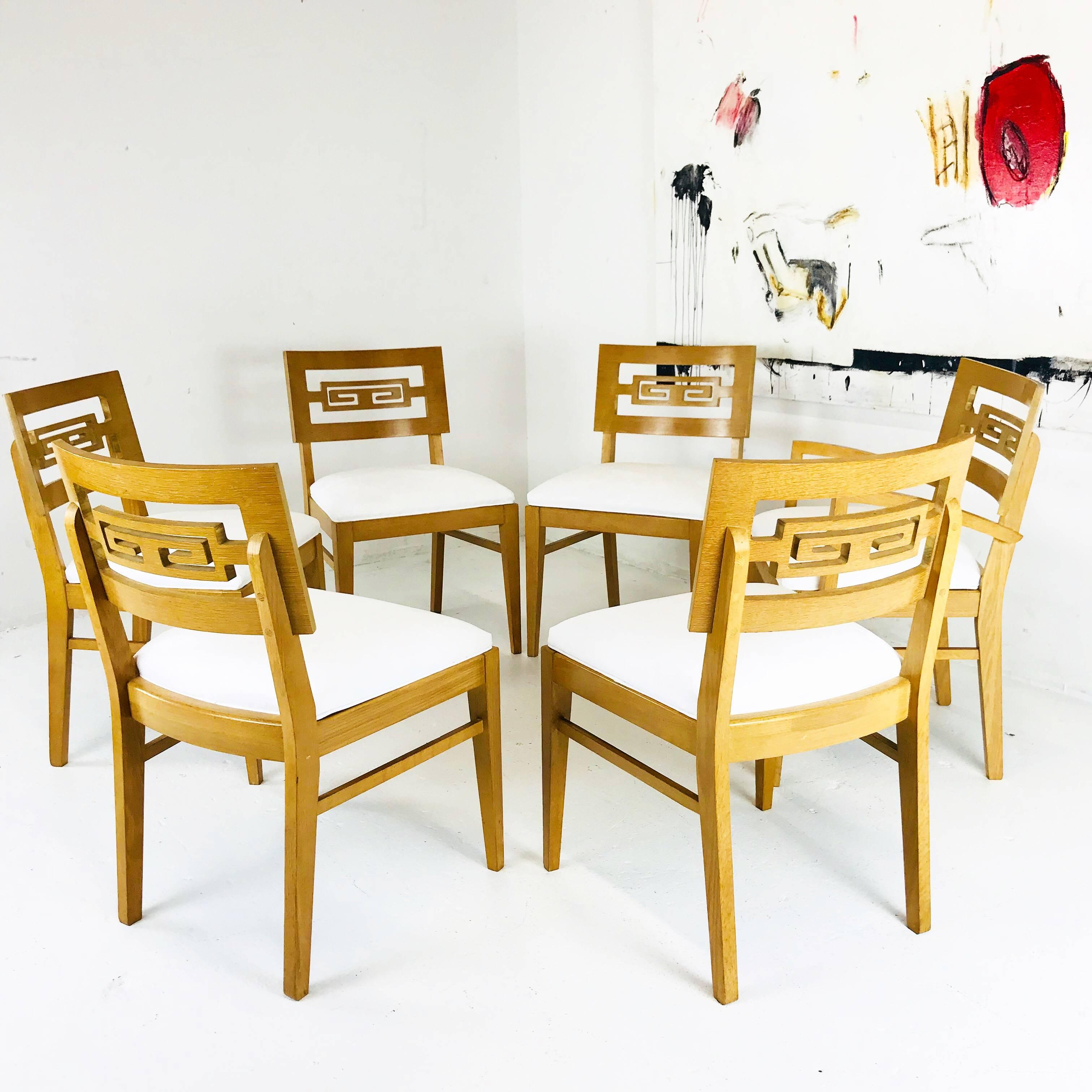 Set of six Greek key dining chairs. There are five side chairs and one armchair. Seat cushions were recently upholstered. Wood finish is in good vintage condition with signs of wear due to age and use, circa 1960s

Dimensions:
22.5