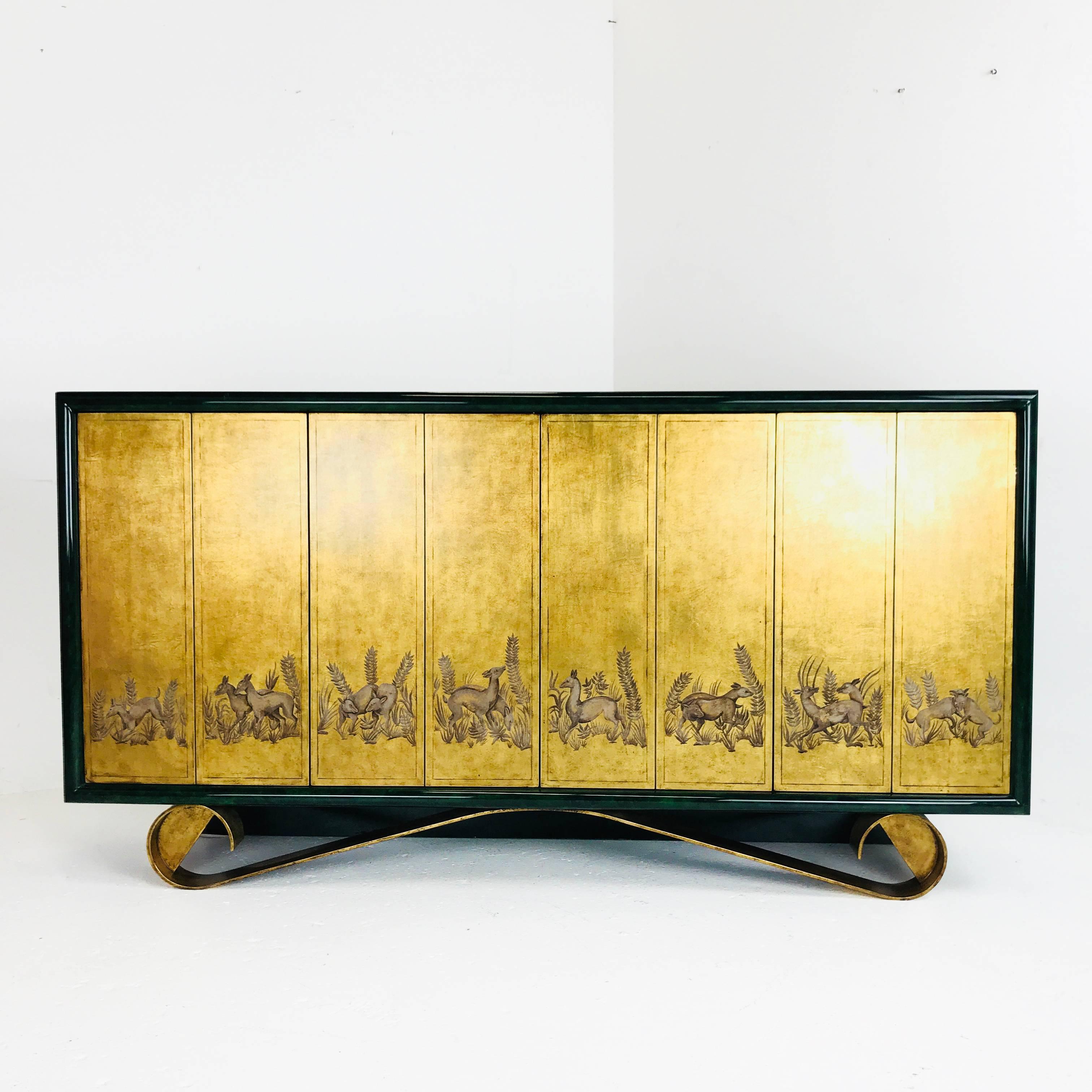 A true work of art, this Cassetto sideboard by Jean de Merry features four touch latch doors with animal motifs on a gold leaf background, gilded scroll metal base and a midnight green gloss lacquer finish.

Dimensions: 72