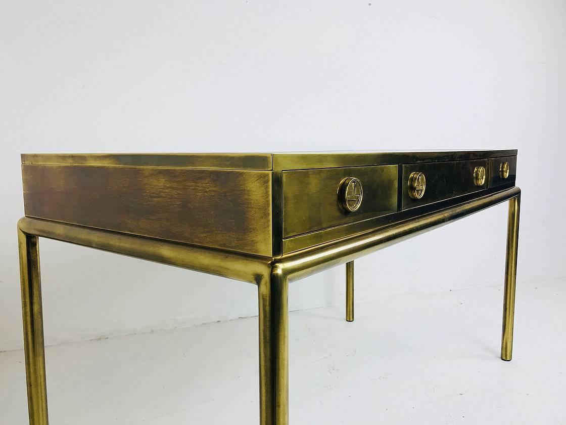 Mastercraft brass desk. In good vintage condition with a leather top insert that we recommend replacing, circa 1970s. Desk is brass and the legs and frame are brass plated with wear in front under middle drawer. See photos.

Contact for more