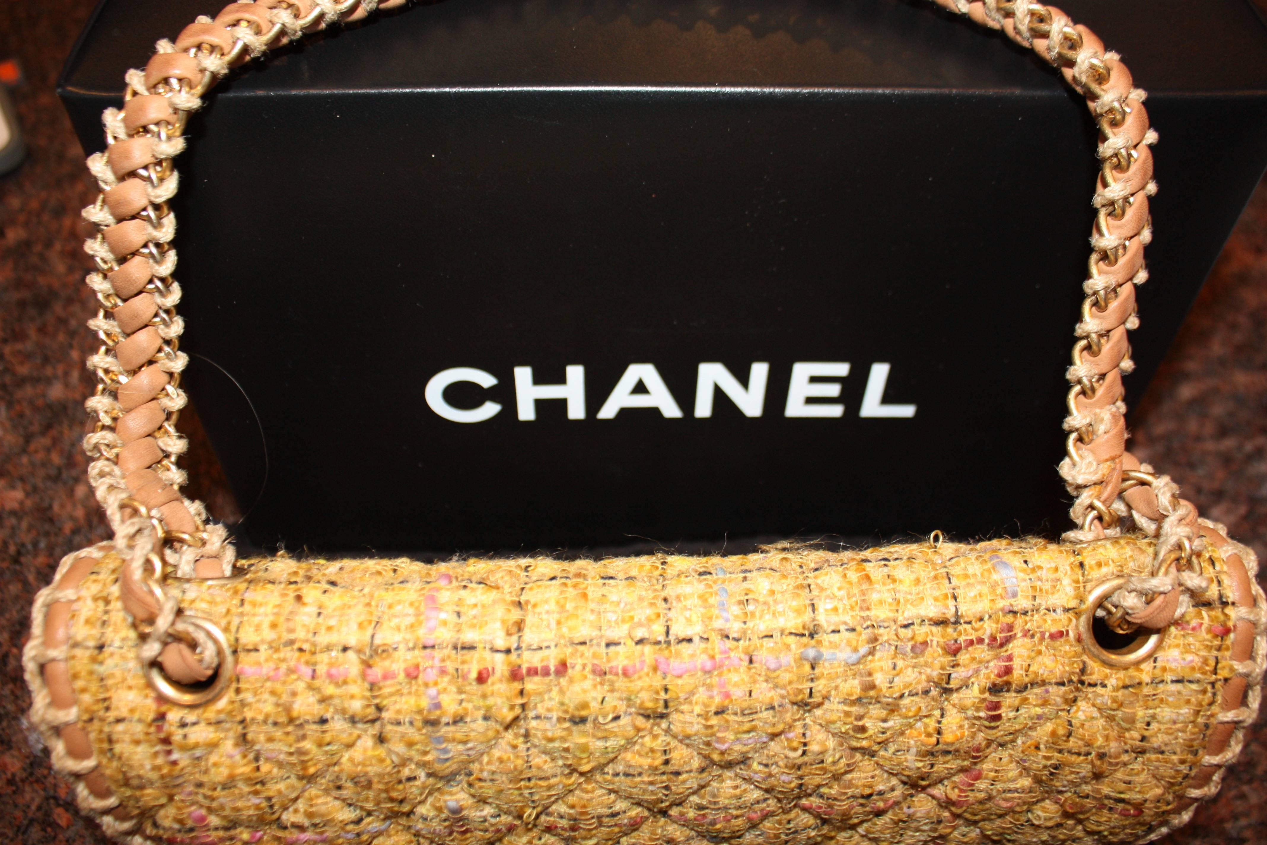 Mustard and multicolor Chanel bag from recent collection.  Gold hardware, beige leather trim and lining.  Woven chain link shoulder strap, single pocket at back.  Pristine condition
16