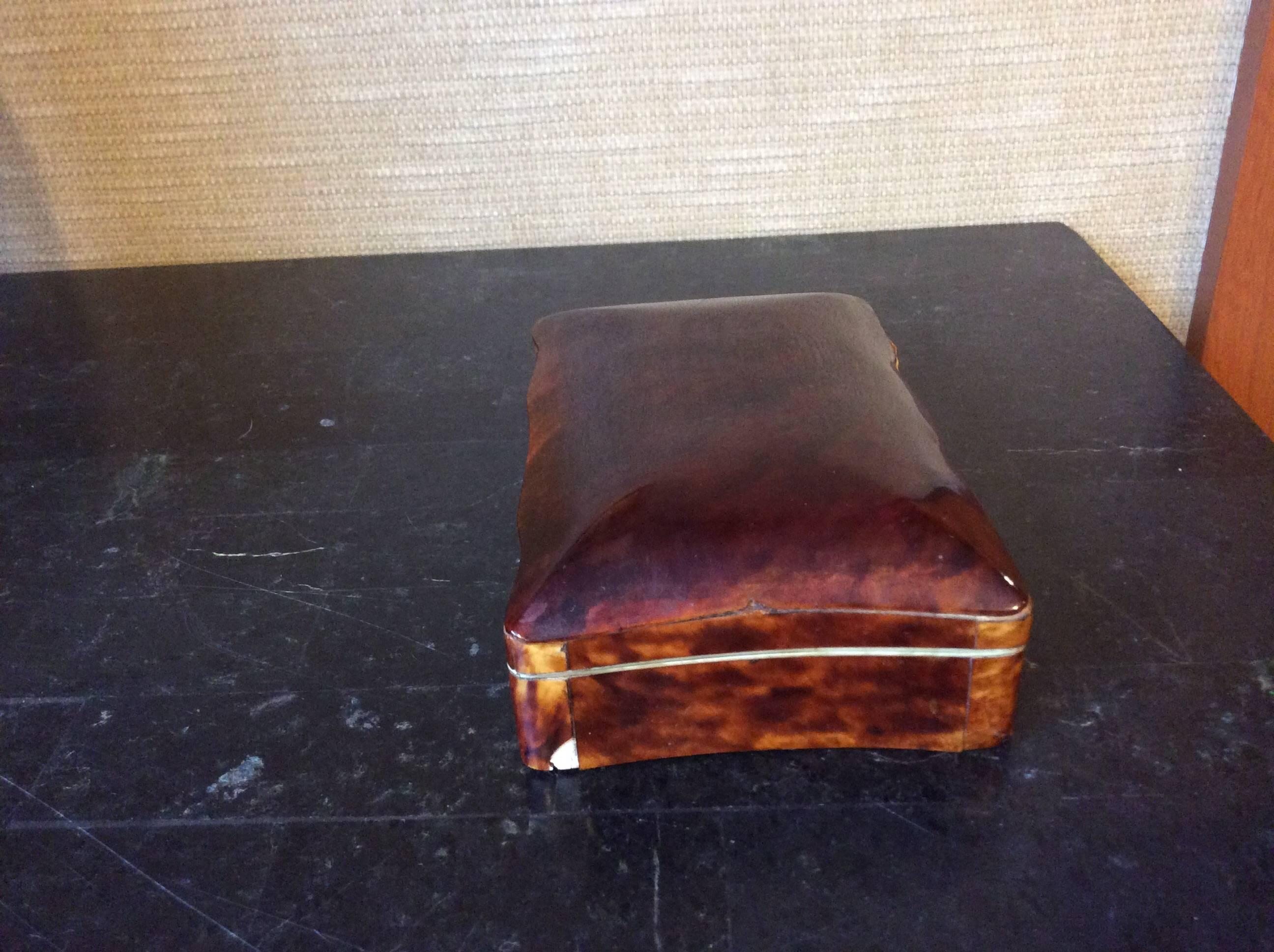 Wonderful old tortoiseshell box. One small chip on right side and old tape on the inside lid. I believe it was to hold the shell to the rim. Please see photos.