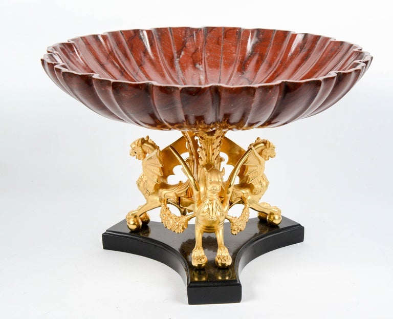 Exceptional red marble cup, supported  by golden  bronze dragons  resting on a base of black marble