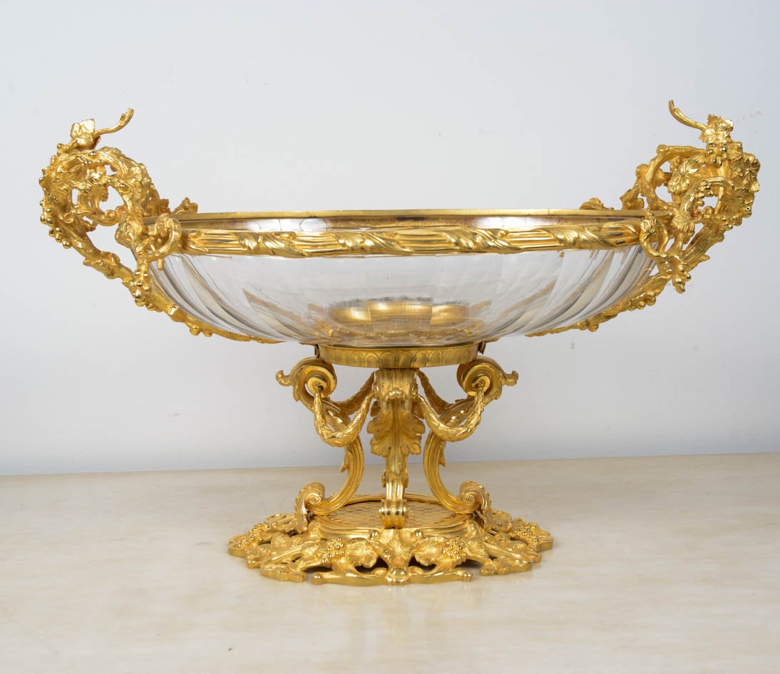 Crystal and bronze  table centerpiece .
  Crystal cup is holding by  a gilded bronze base  with  decor of grapes  very finely chiselled.
