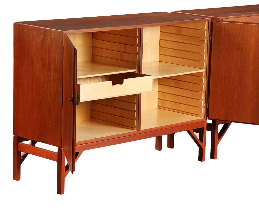 A pair of patinated teak sideboards or cabinets, model A 232, front with two doors. Interior with shelves and trays. Special brass keys and fittings. These examples manufactured 1960s by C.M. Madsen for FDB, stamped by maker.

Literature: FDB