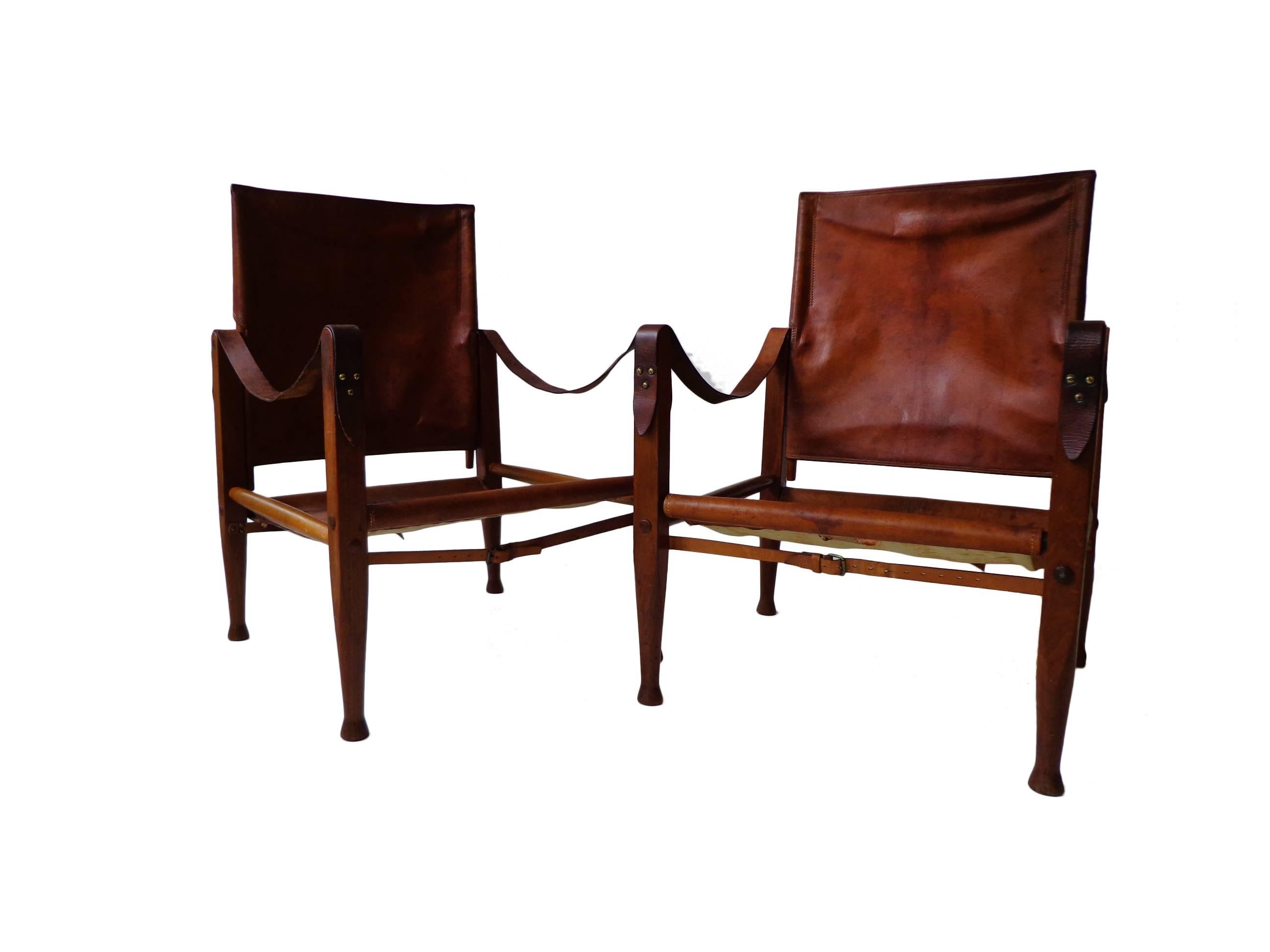Offerd by Zitzo, Amsterdam: A pair of stained ash "Safari chairs". Seat, back, armrests in original patinated cognac niger leather and brass details. Designed 1933.
Signed with early applied manufacturer's label to each