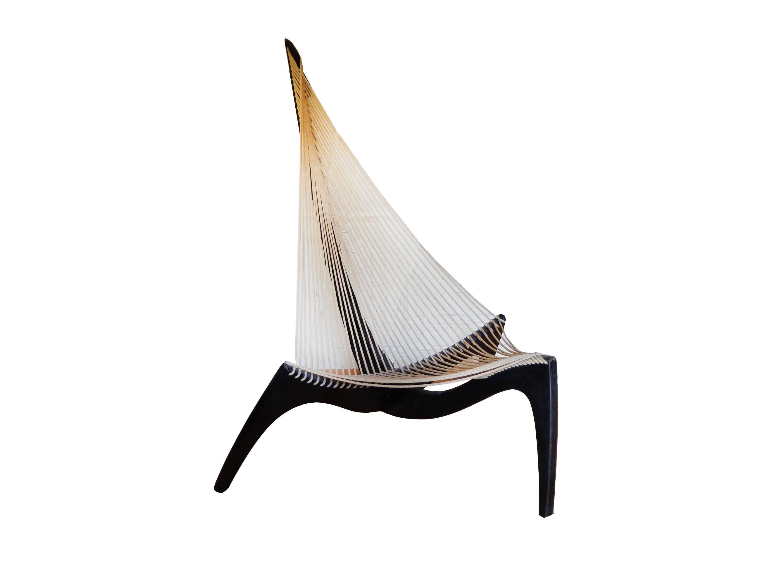Offerd by Zitzo, Amsterdam this early Harp chair shape gives it the name Harp chair. Its three wooden legs have curves like those of an old Viking ship. The legs are joined in the centre with a single metal bolt, providing for a knockdown feature.