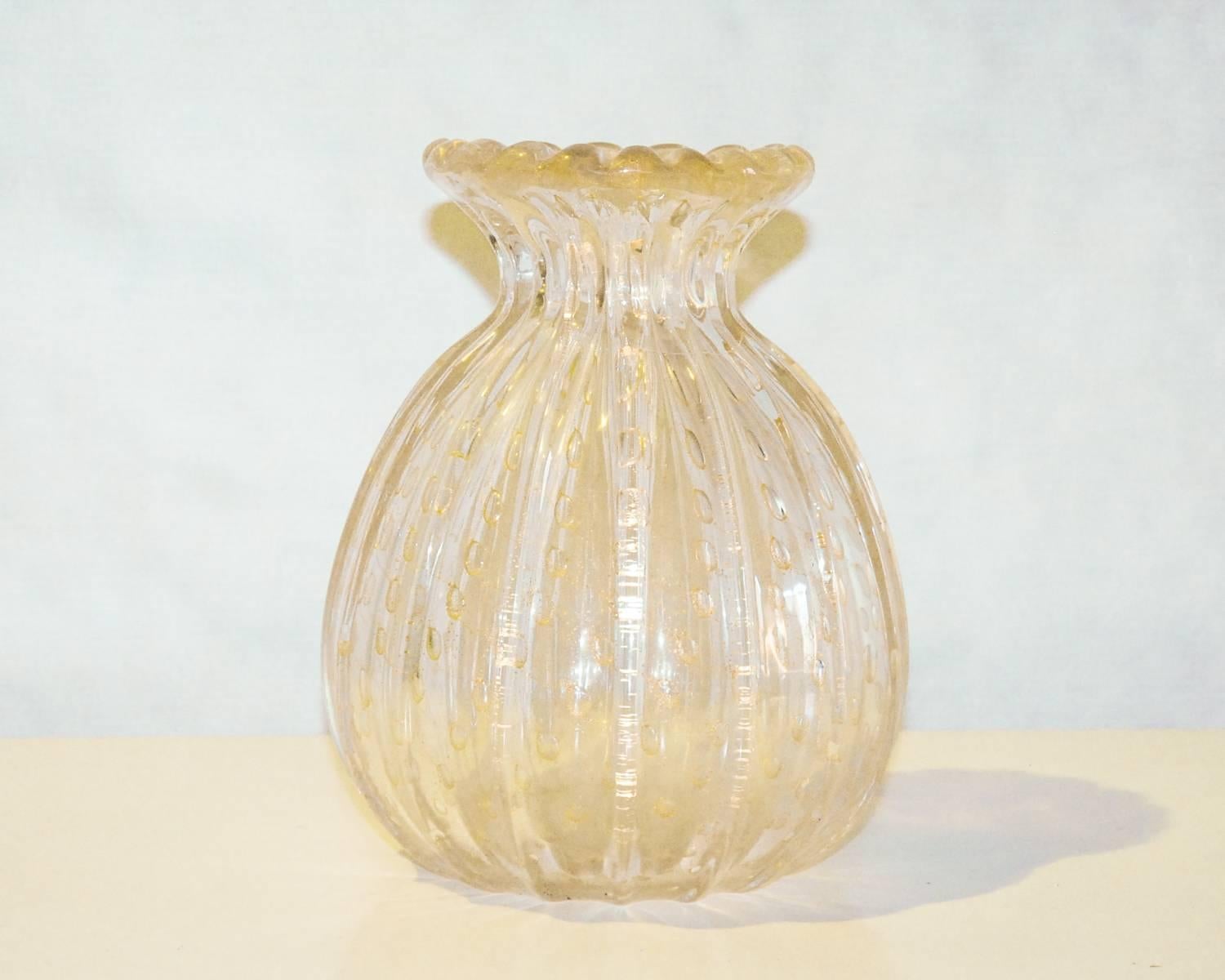A controlled bubble Murano vase with gold foil inclusions in a clear glass ribbed body by Toso Murano. The vase is signed Toso Murano on the base. A superb example of Italian glass blowing at its best!