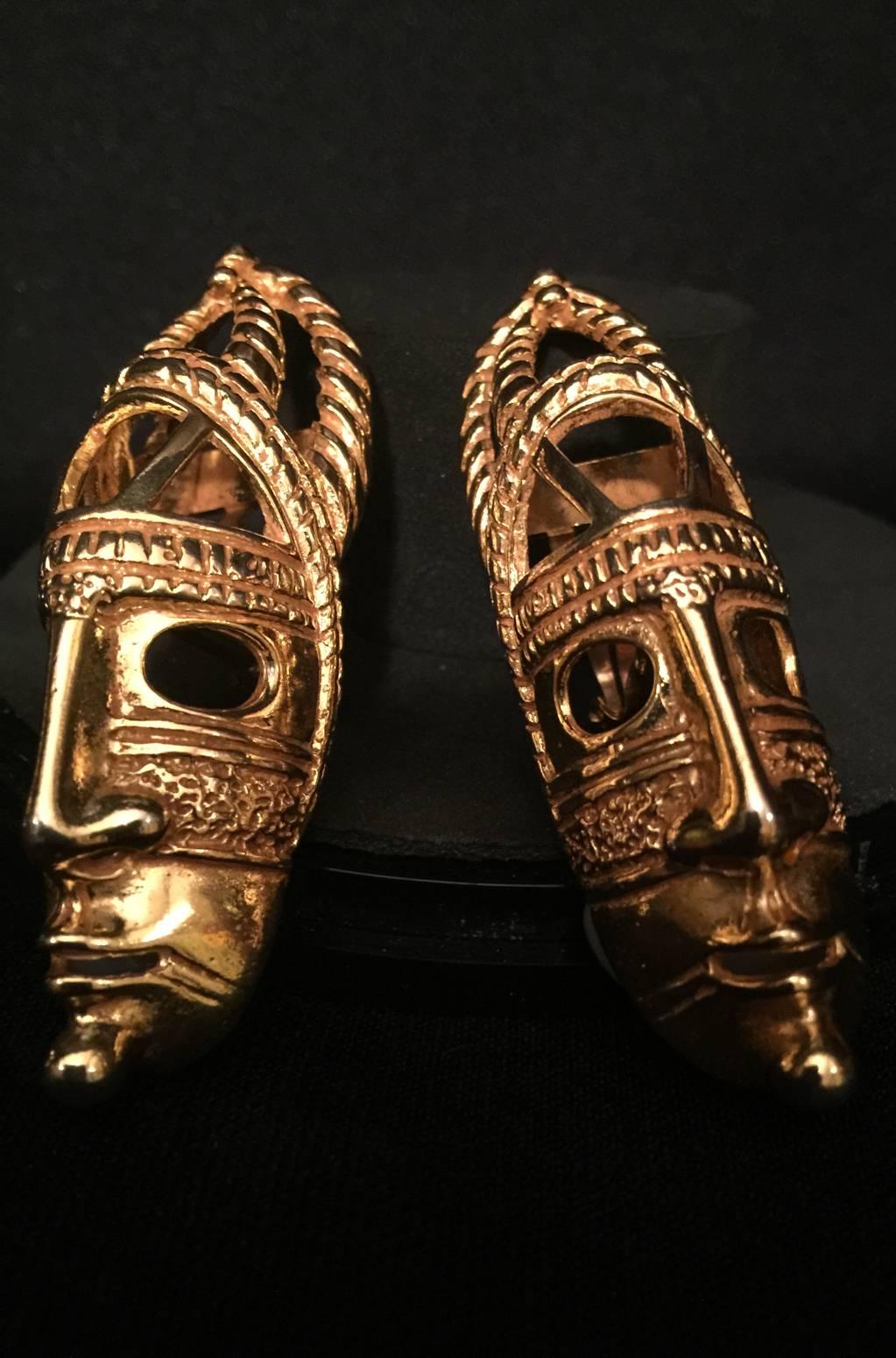 A striking pair of goldtone tribal mask earrings by master jewelry designer Dominique Aurientis.  Signed Dominique Aurientis PARIS in an oval. These earrings will 