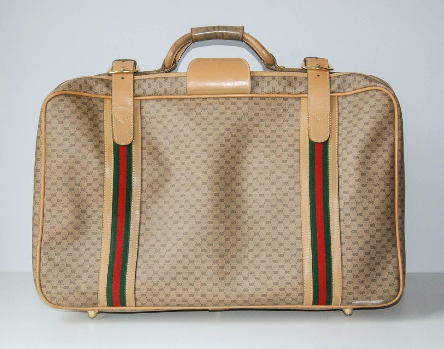 Travel in high style with this superbly crafted Gucci suitcase.  The interior includes Gucci monogrammed clothing tie-downs and the brass Gucci nameplate and embossed leather serial number.  The exterior includes the impressed signature to the brass