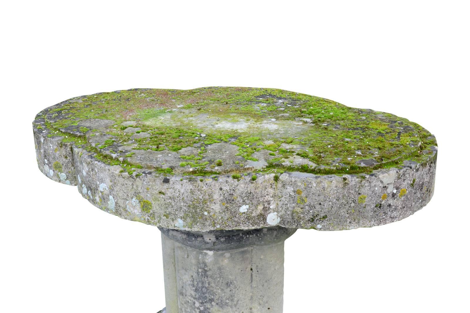 Stone garden table circa 1820, consists of a quadrilobe thick plate resting on a molded base also quadrilobe.