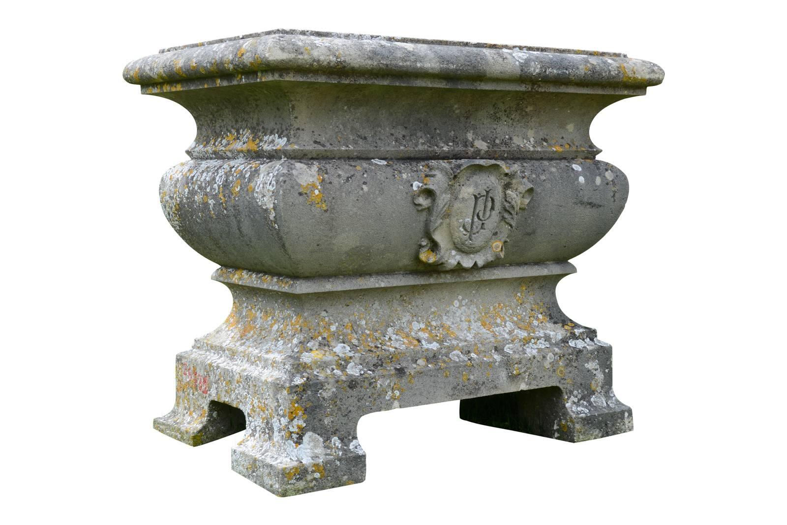 A French Napoleon III stone tub dated late 19th century. The molded edge, decorated with a central cartouche having the initials P and J entwined, rests on four feet. Nice old patina.