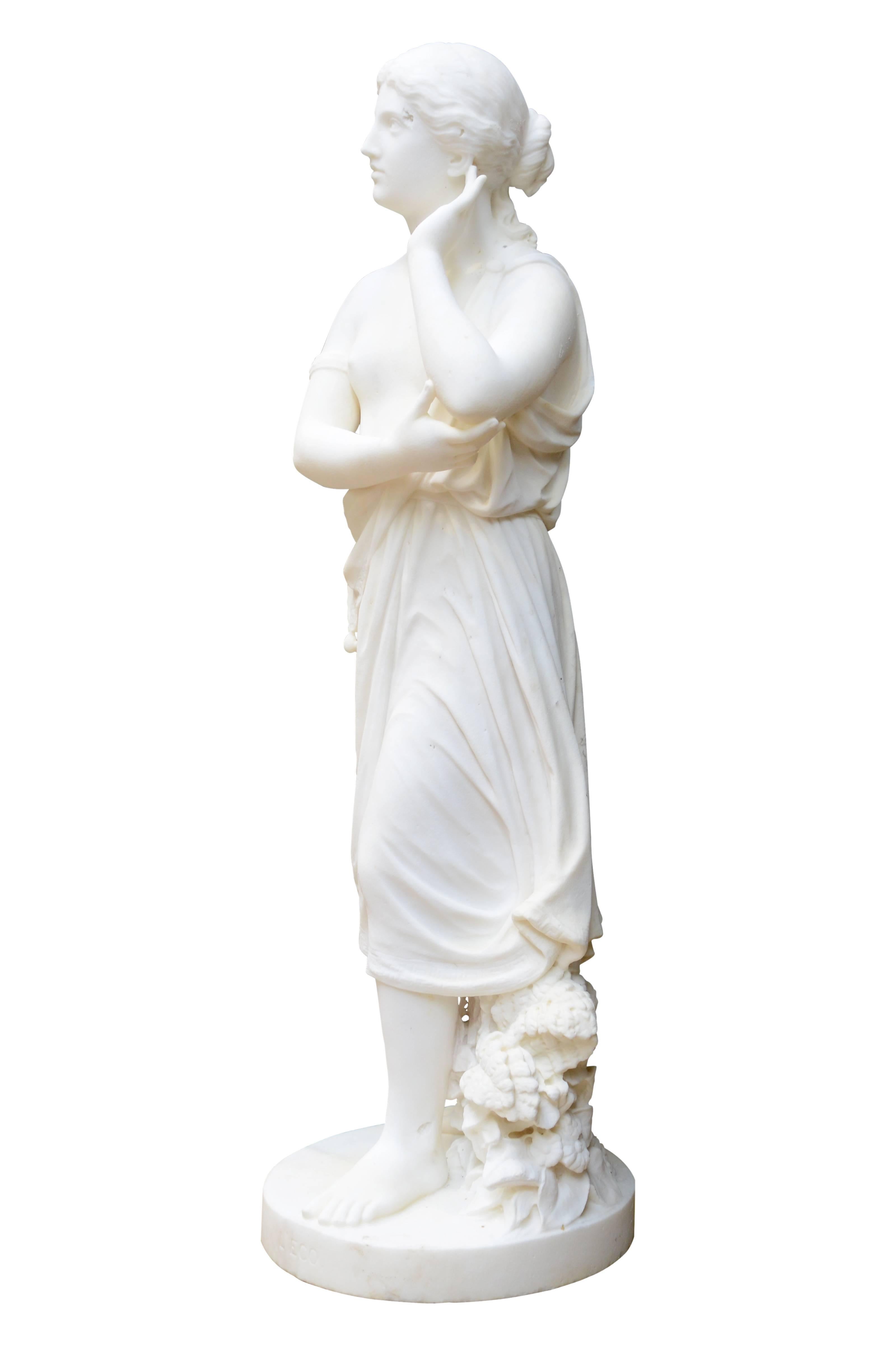 Dated from the 19th century, circa 1892, white Carrara marble statue representing the mythological figure of Echo. She is represented here, wearing a draped dress revealing her chest, one hand in her ear, pretending to listen to his own voice, and