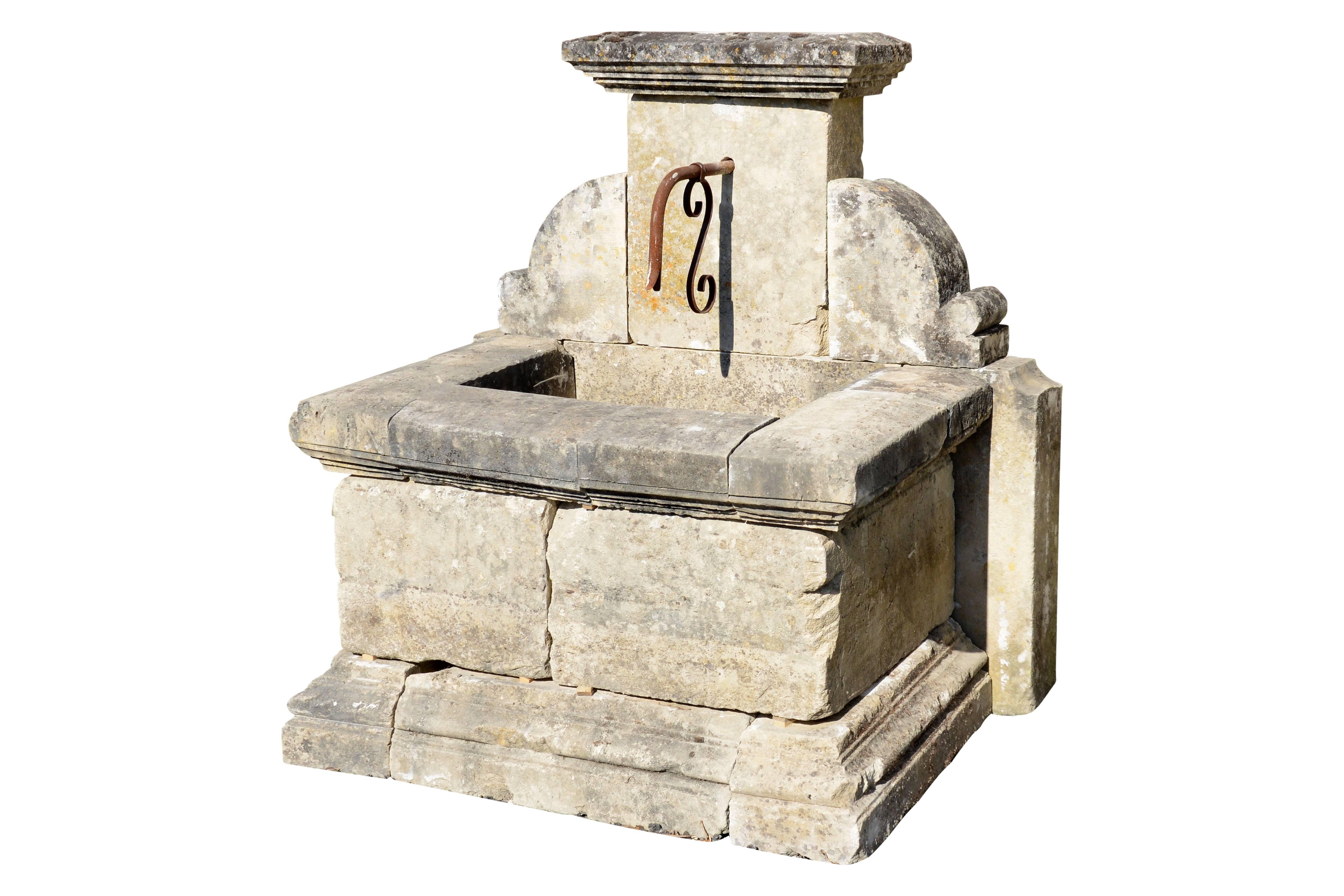 Composition of antique 19th century period reclaimed architectural elements forming a Provençal style wall fountain. The pediment, in the form of pilaster, topped by a degrees cornice, is flanked by molded ailerons on the sides. The centre is