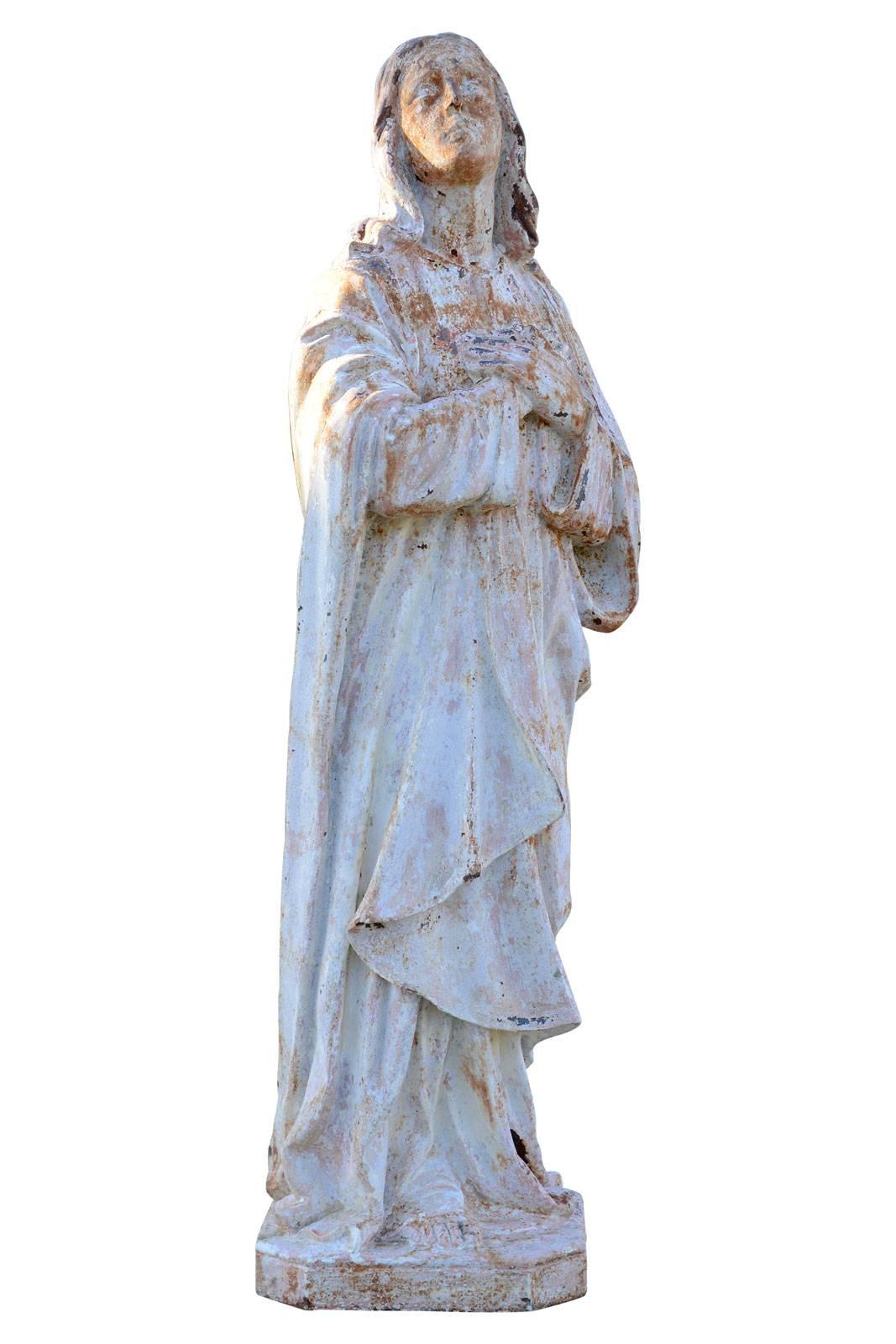 Dated 19th century, cast iron statue representing St. Mary Magdalene, who was near the Virgin Mary and St. John at the Crucifixion. This statue, where traces of color are apparent, was to be near a Calvary. Origin : Ancient Dominican nuns' park of