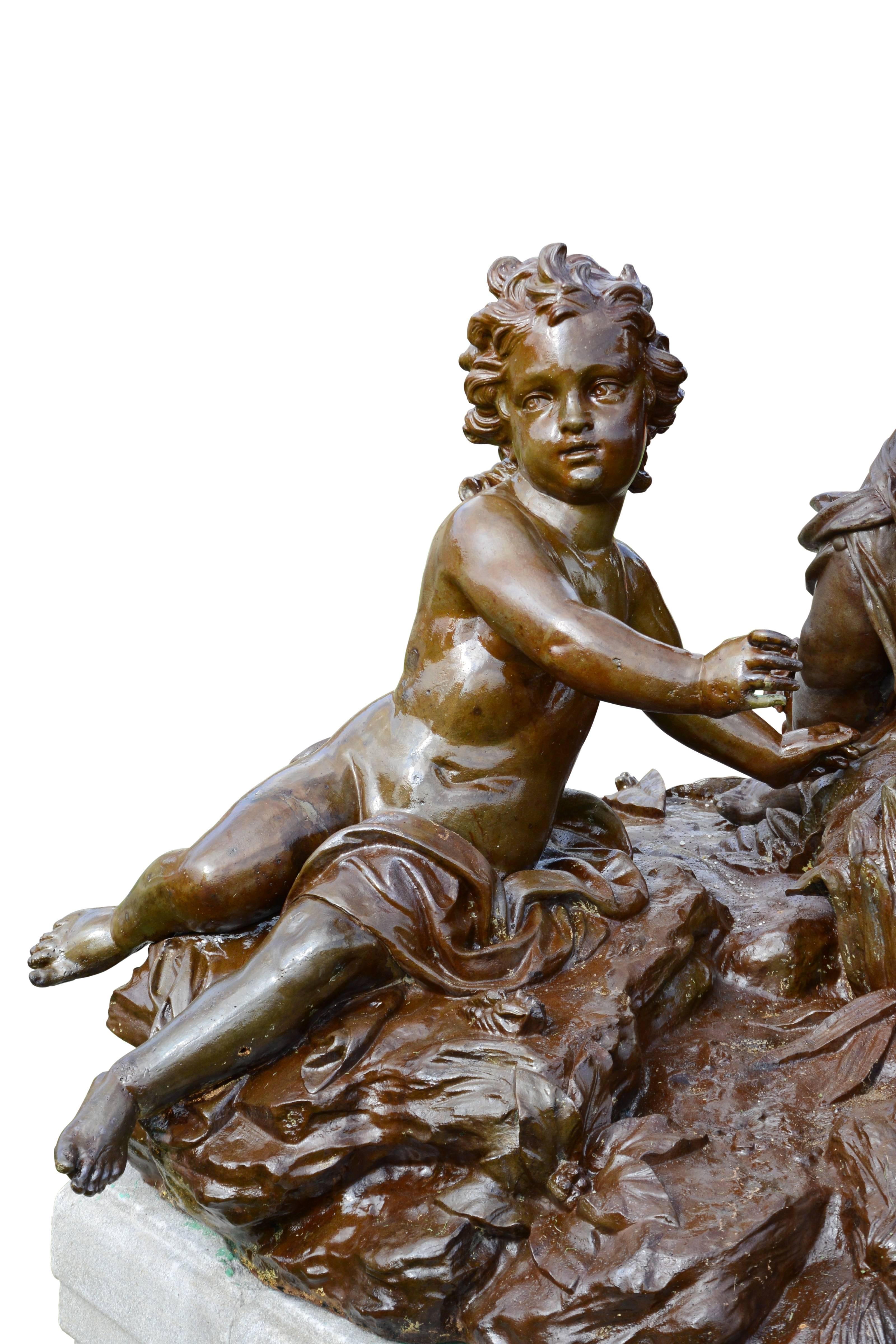 Dated from the 19th century, important cast iron group of putti resting on an octagonal molded granite pedestal. This group represents four children crowned with roses, playing in the reeds and holding flowers in their hands. Lightly clothed, the