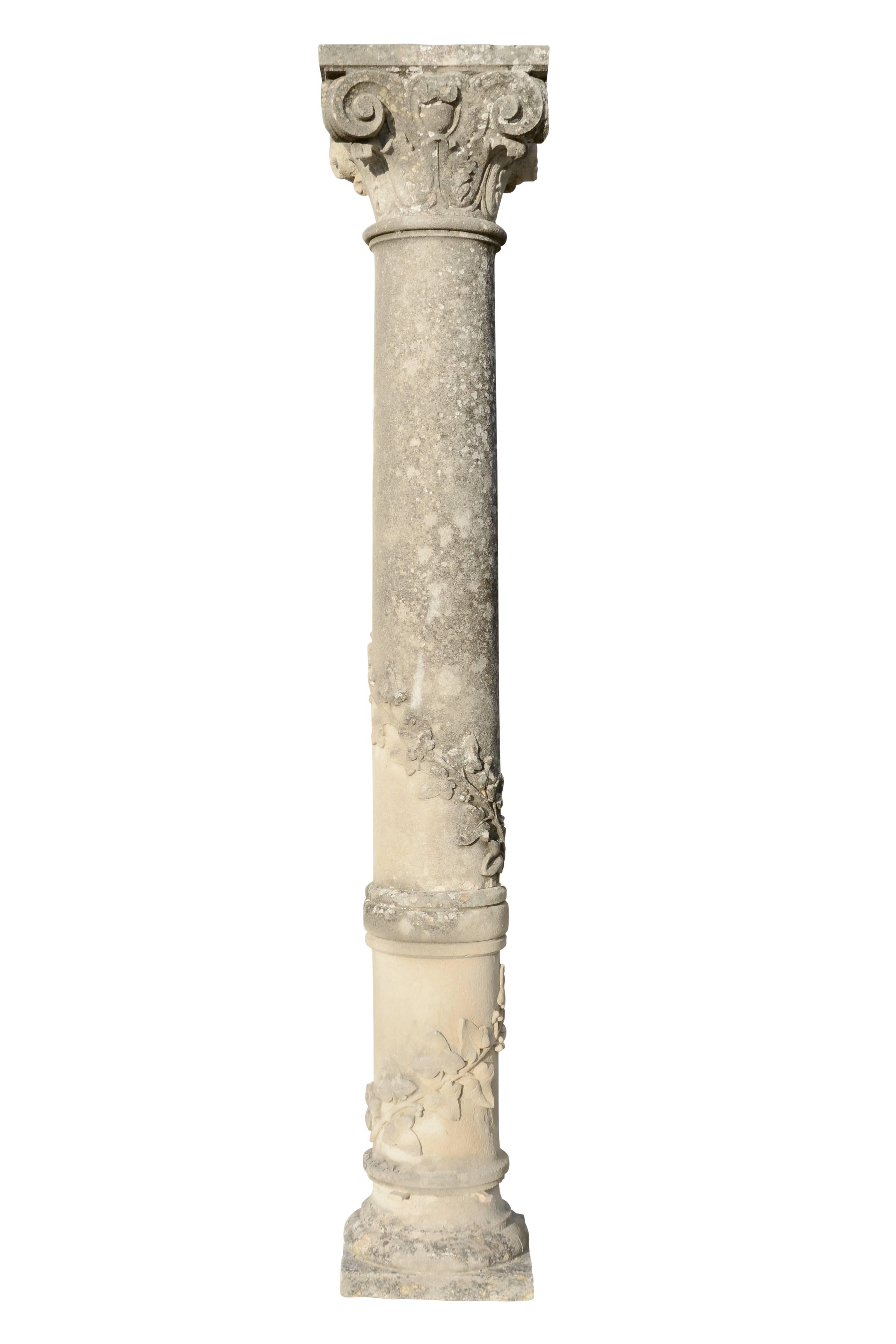 Dated from the mid-19th century, pair of carved stone columns. 
Both are topped by Corinthian capitals and decorated with ivy leaves winding around the molded column.