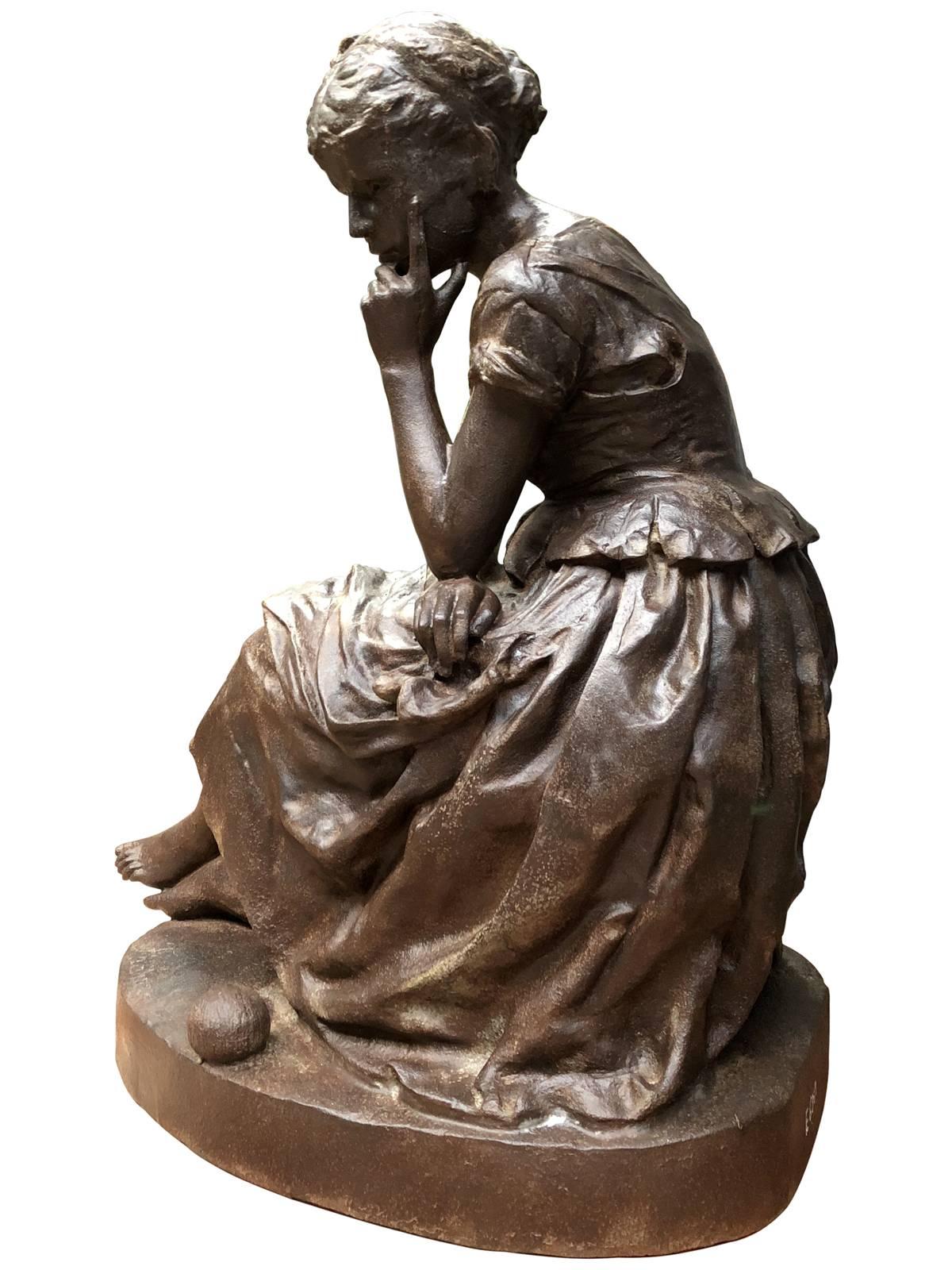 Dated from the late 19th century, circa 1890, cast iron statue representing Cinderella, from Salin foundry. The young girl, wearing a bun and dressed in rags, delicately rests his head on his hand. Next to his bare feet, dragged a ball of wool. On