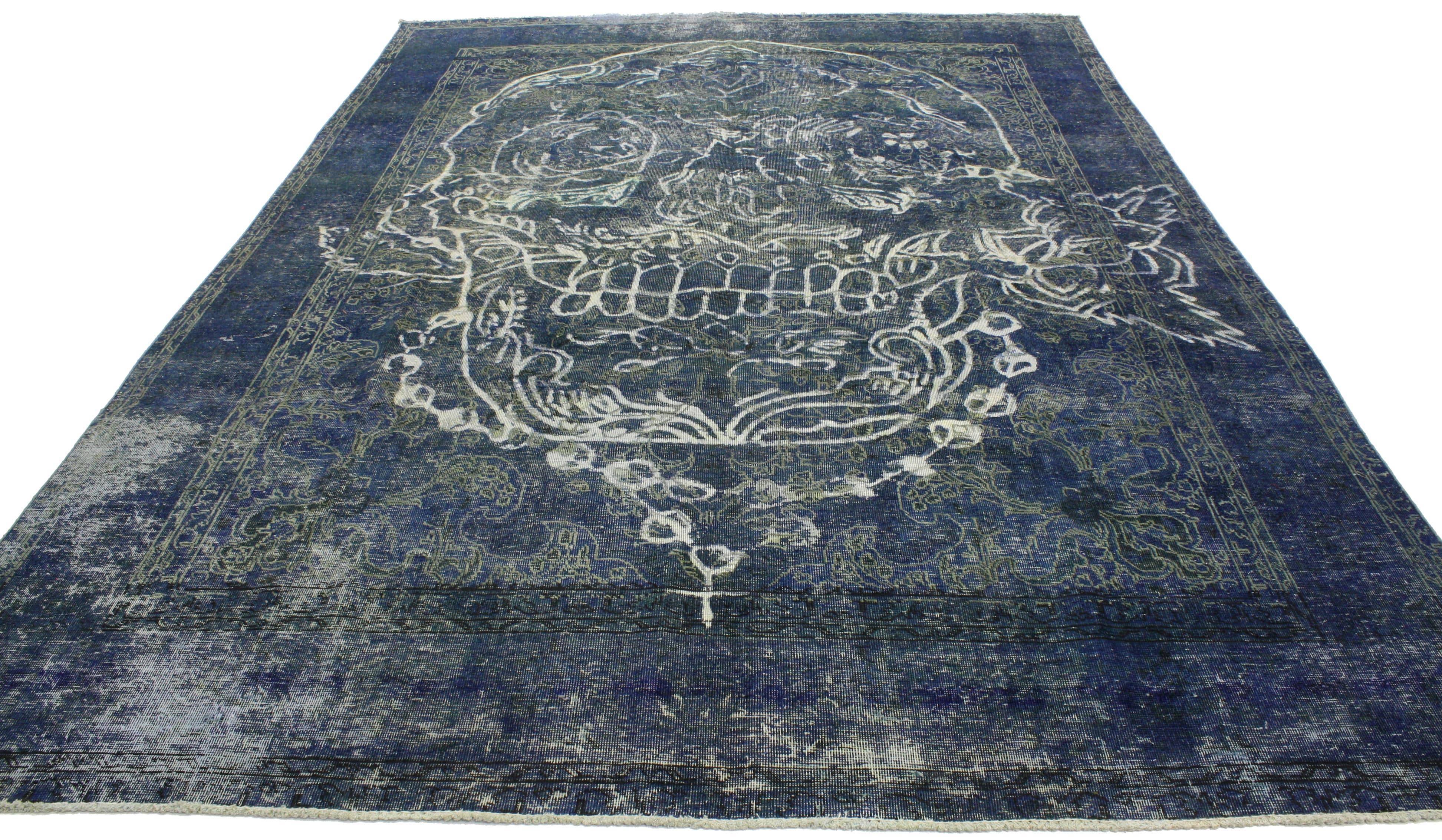 This overdyed vintage Persian Tabriz rug in blue is far from plain and simple with its alluring and meaningful composition. In this unique distressed rug, the intricately illustrated skull and rose has been given a sophisticated twist by designing