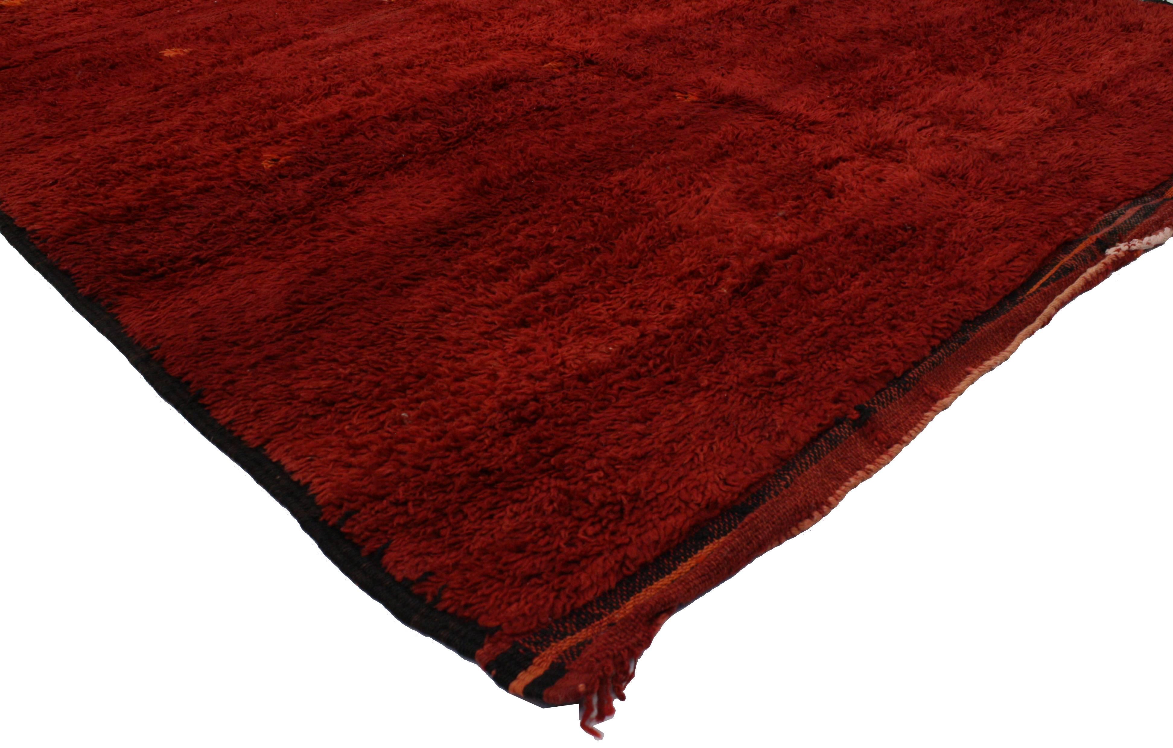 This is an absolutely stunning and impeccably made Moroccan carpet. With its show-stopping red color and luxurious blend of modernism and Berber history, this Moroccan beauty will work well with both Mid-Century Modern and transitional interiors.