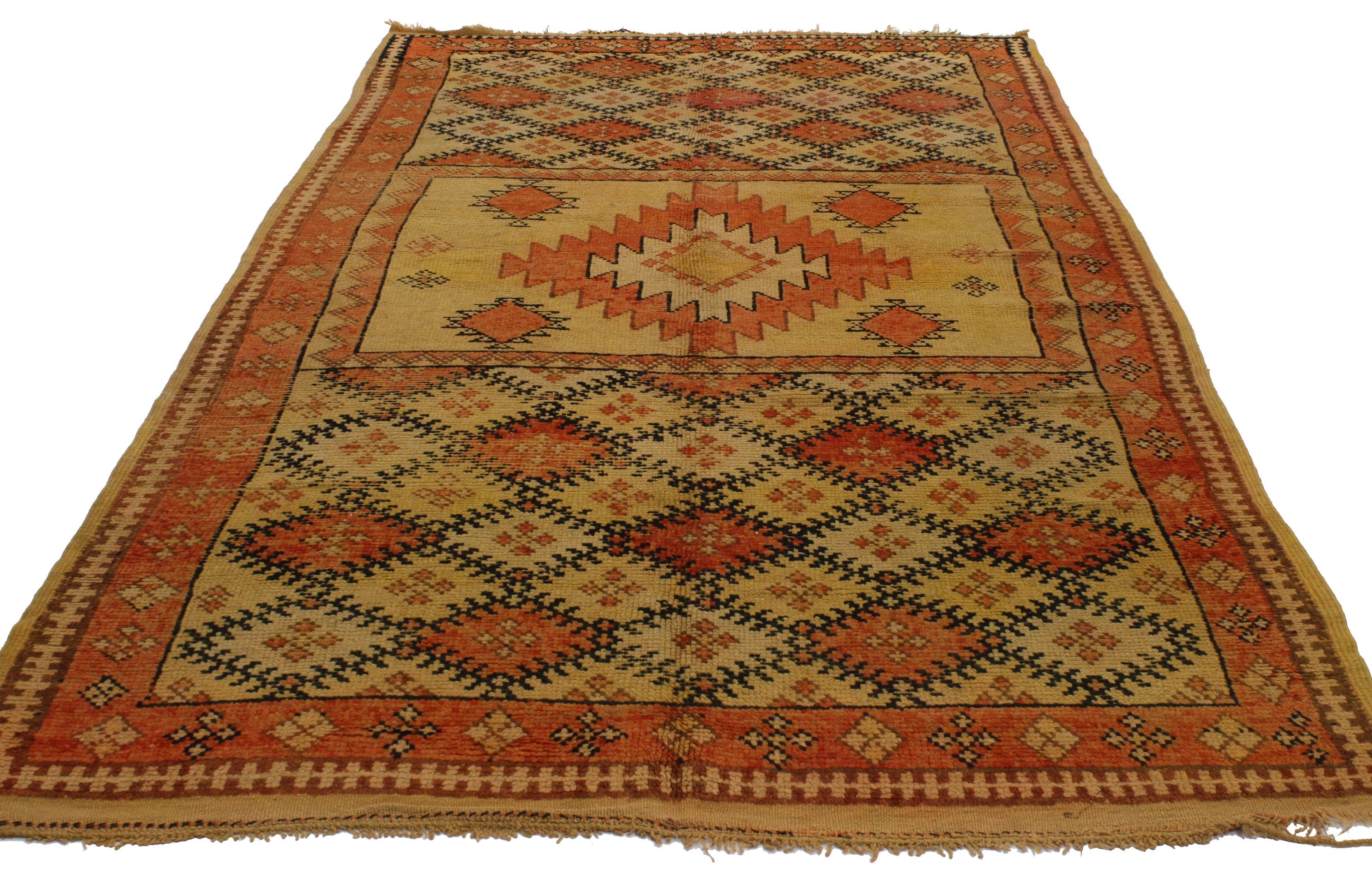 Featuring vibrant colors of turmeric orange, golden saffron, cinnamon and warm brown sugar, this Berber Moroccan rug is reminiscent of sweeping desert landscapes and the smell of incense carried by the warm afternoon breezes. The incredibly