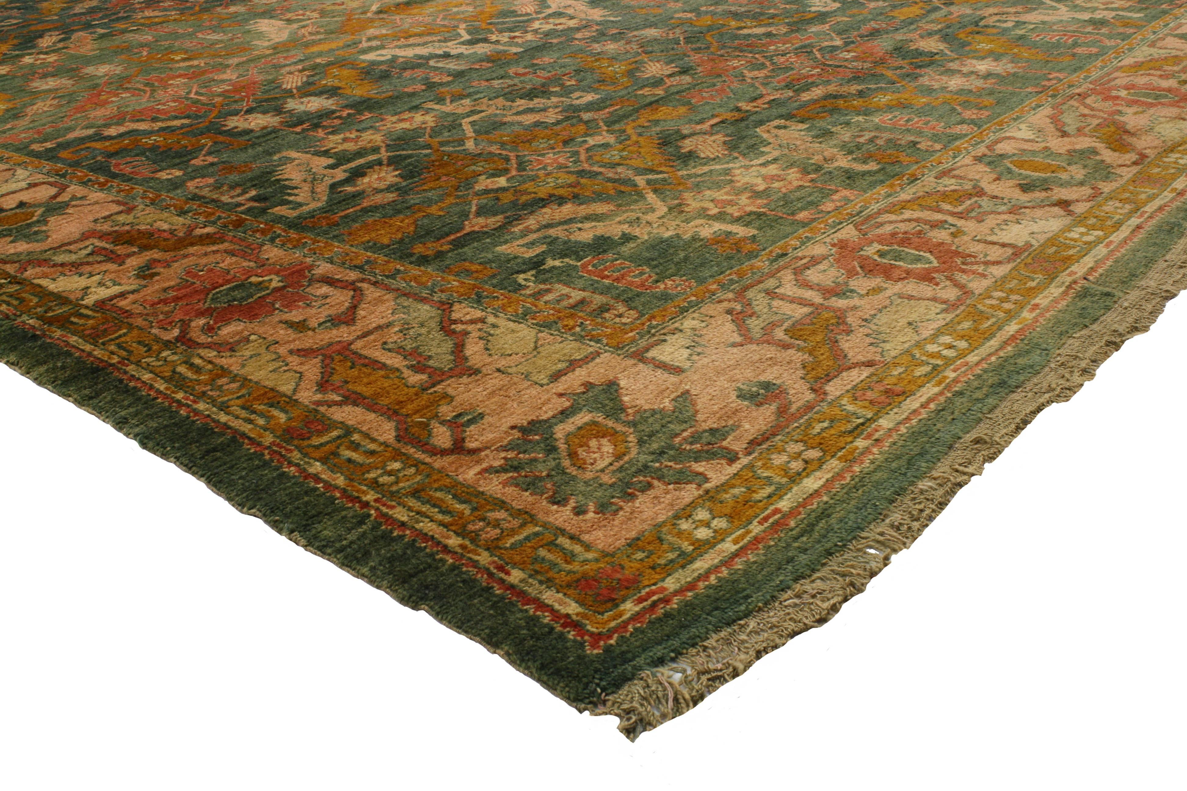Surreal shades of green, salmon and warm golden saffron yellow characterize this ethereal antique Turkish Oushak rug. Featuring a large scale all-over pattern embellished with serrated geometric motifs, the astounding complexity and sincere beauty