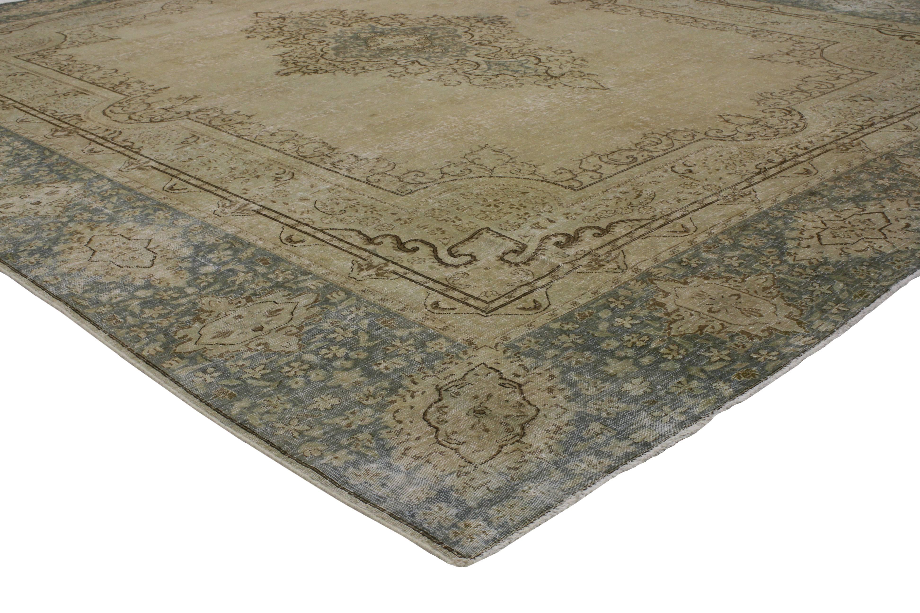 Subdued neutral colors and an elegant combination of texture and pattern create a calm base for this vintage Persian Kerman rug modern Industrial style. With its distressed composition, idyllic open field of beige combined with a cool slate gray