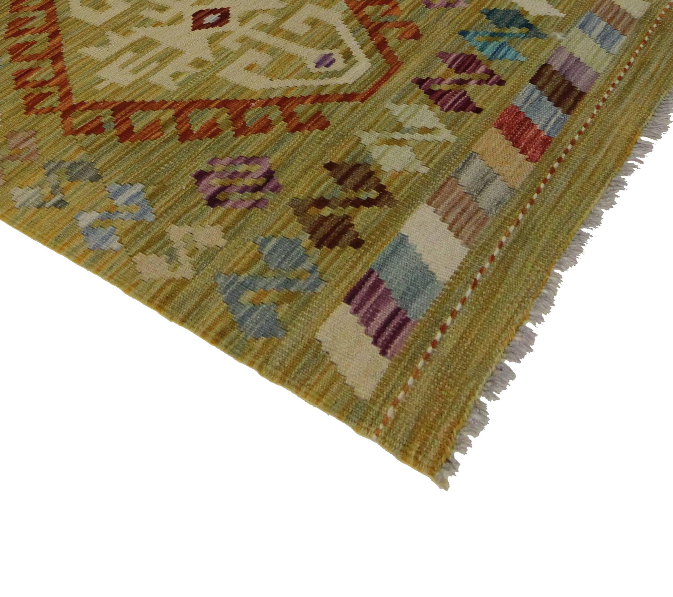 This charismatic modern Afghani Tribal Kilim rug with Boho Chic style is anything but boring. This handwoven wool flat-weave Kilim rug features an all-over geometric and tribal pattern in a vibrant color palette. Blending the graphic appeal and Folk